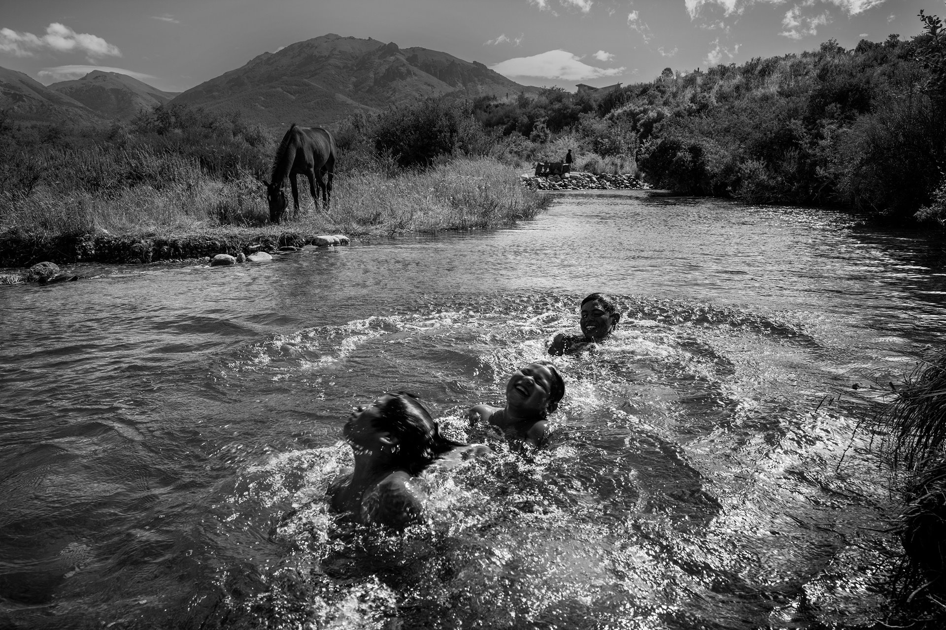 Cousins and friends of Rafael Nahuel swim in the Ñirihuau River, in Bariloche, Rio Negro, Argentina. Nahuel (22) was shot in the back during a raid by government forces on Indigenous activists in November 2017. He was supporting Mapuche groups who had occupied ancestral territories in Patagonia. In 2023 five members of an elite police squad were convicted of his murder.