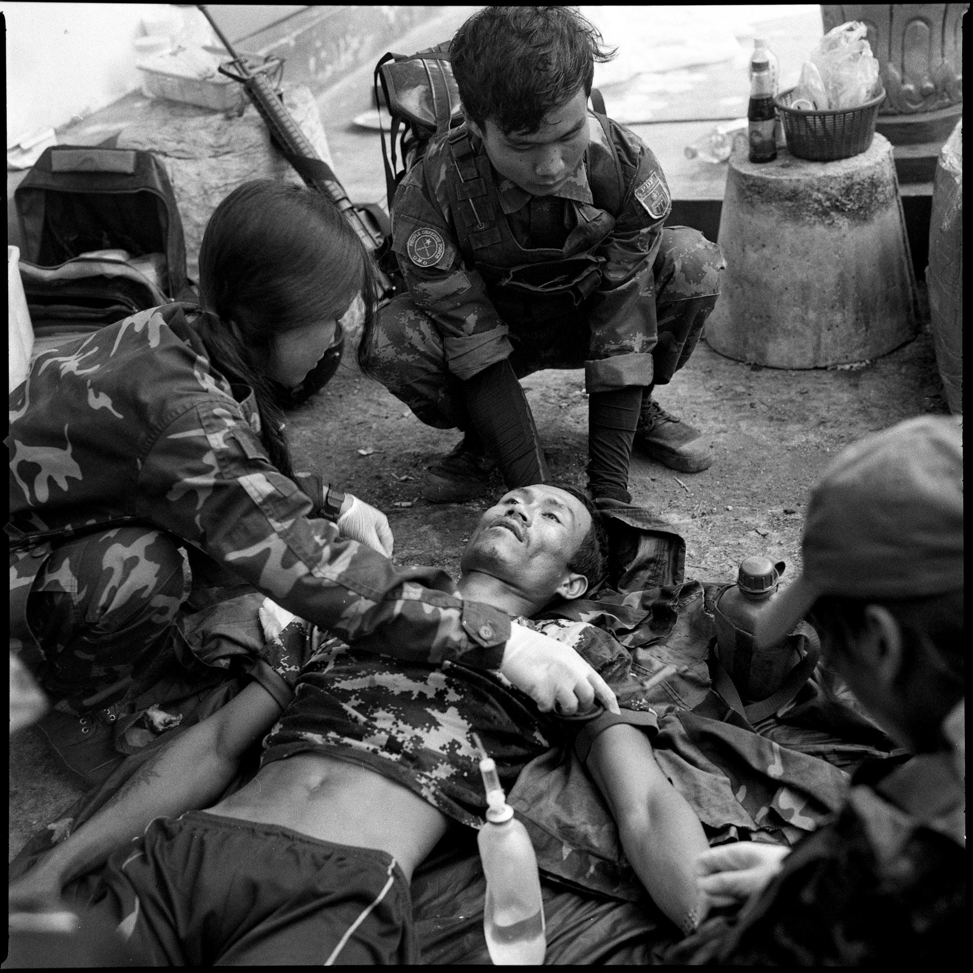 A combat medic examines the body of a People&#39;s Defense Force (PDF) fighter killed during a battle in Operation 1111, in Loikaw, Kayah (Karenni) State. Operation 1111 was a military operation launched by several combined resistance forces to capture Loikaw, the capital city of Kayah State.