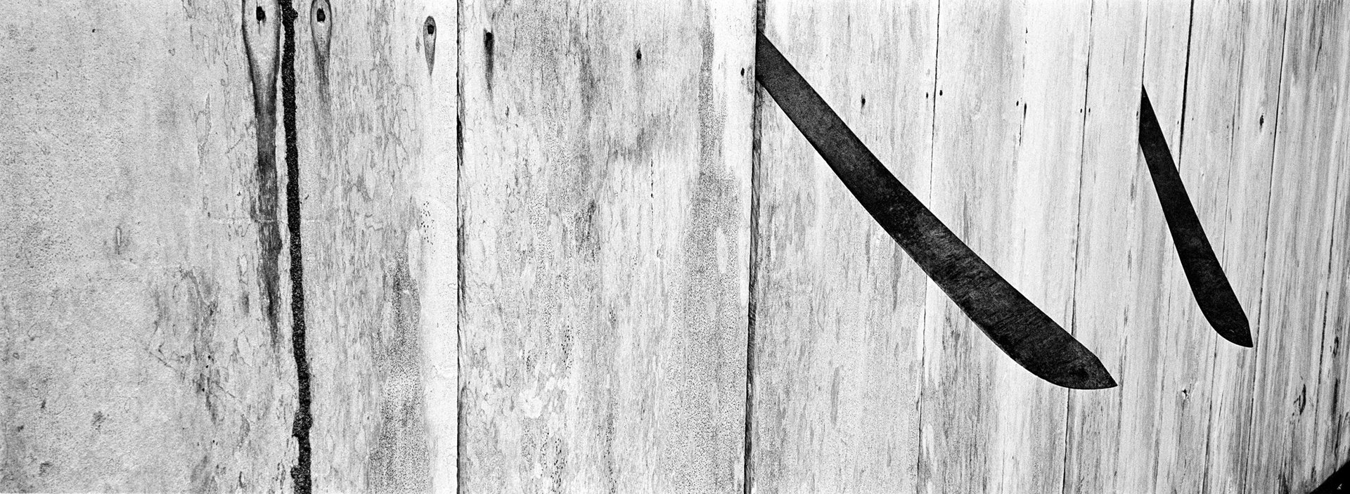 Machetes protrude from the wall of a wooden house in Puerto Nariño, a small town in the Colombian Amazon region. Many victims of forced disappearance in Colombia have been killed and dismembered using machetes and chainsaws.