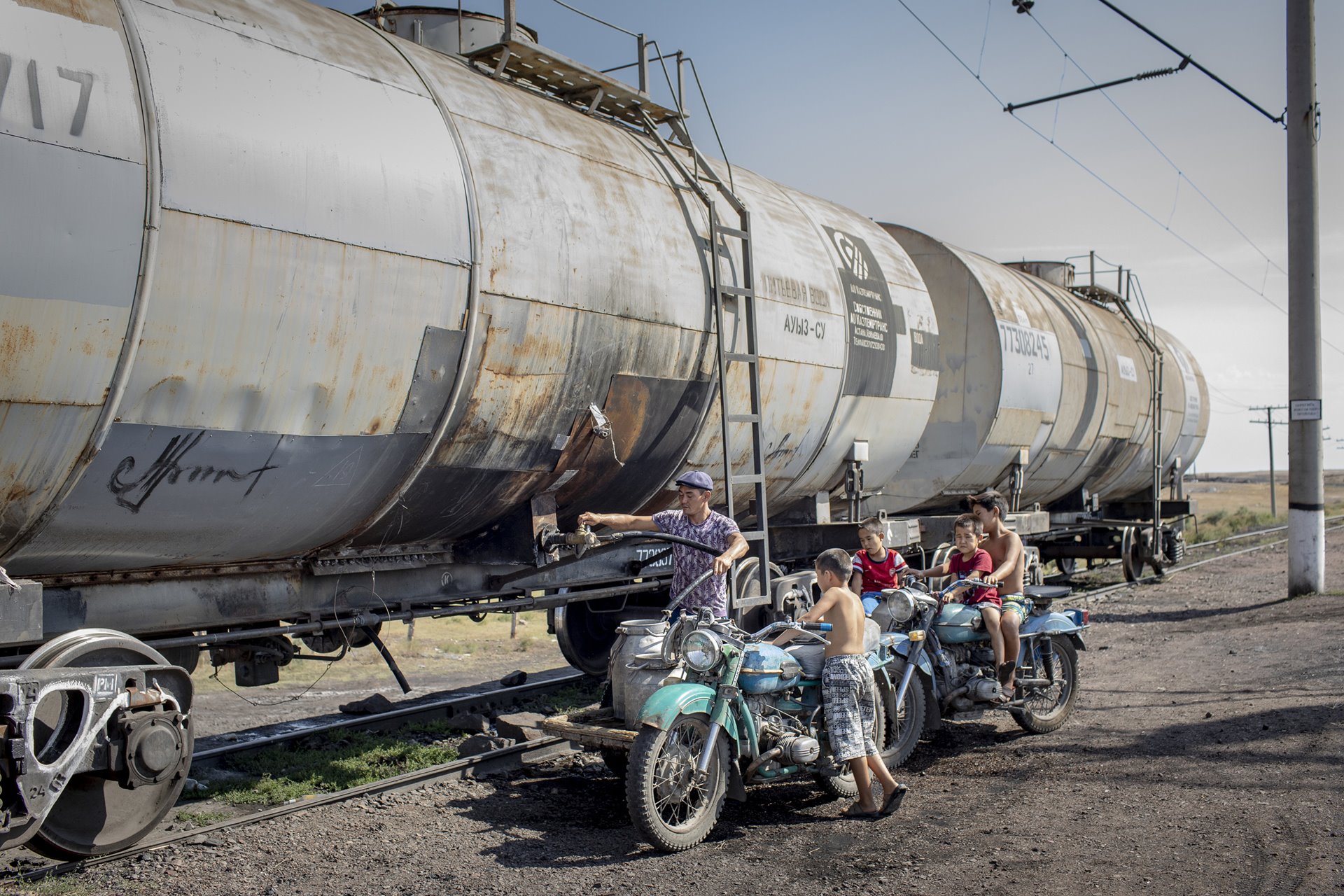 People fill containers with water in Kiyakhty, Kazakhstan, south-west of Lake Balkhash. Water is scarce in much of the surrounding Jambyl region; in Kiyakhty, the single source of water is a wagon train arriving once every two weeks.