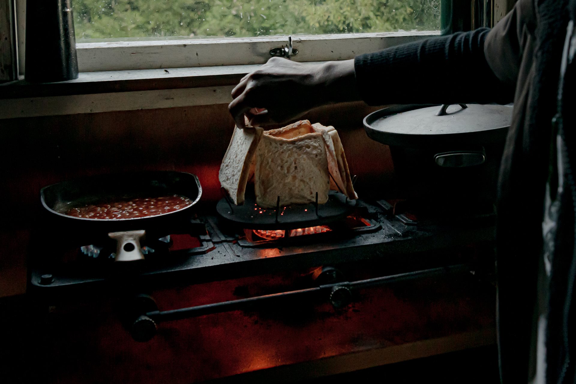 Mereana Williams-Te Kura prepares breakfast in the remote house she looks after in the Te Urewera rainforest, in Maungapōhatu, New Zealand.