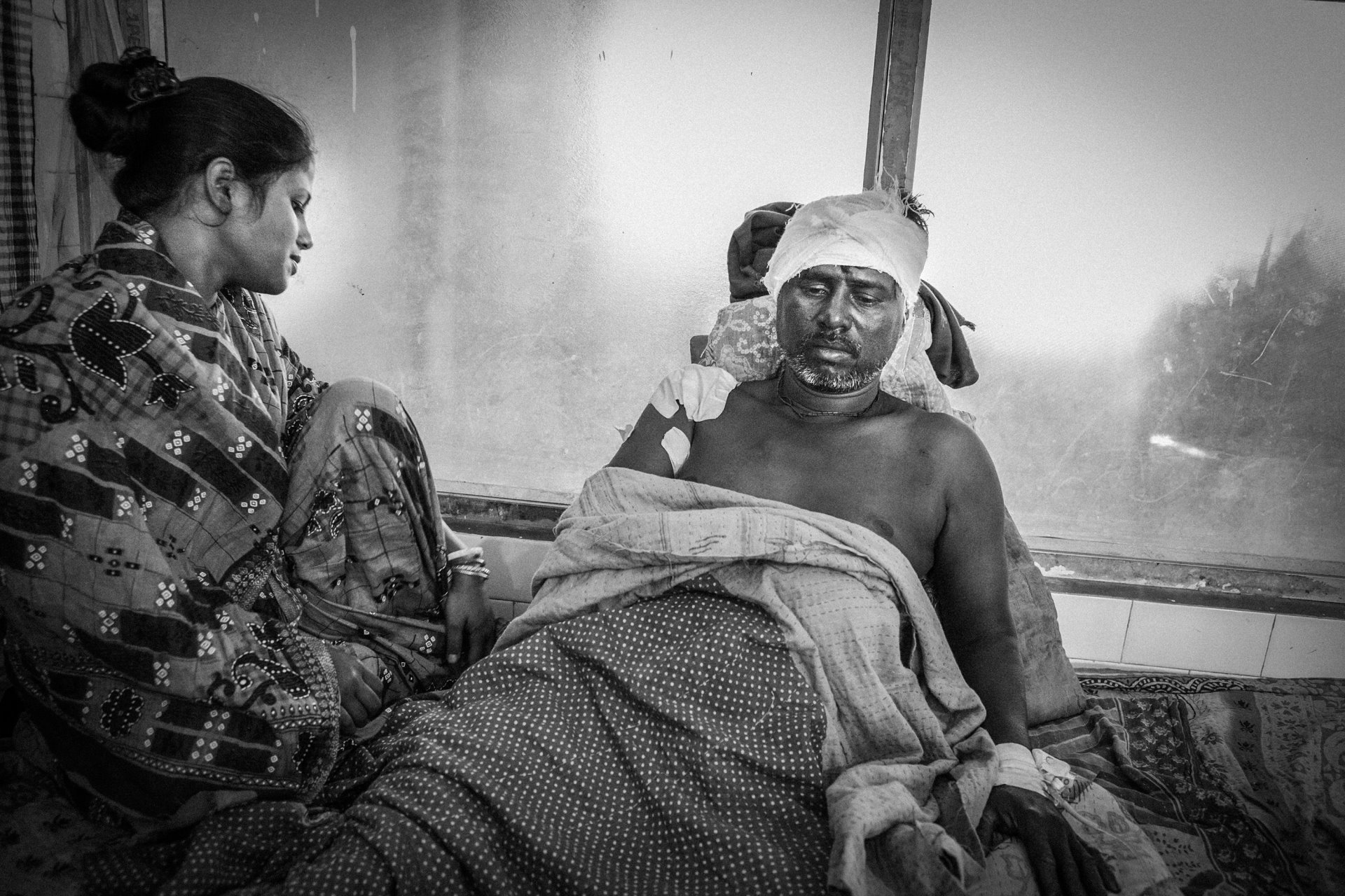 <p>Manoranjan Biwas lies seriously injured after being attacked by a tiger when he was collecting crabs in the forest buffer zone of the Sundarban Tiger Reserve, in a delta region of West Bengal, India. Biwas is waiting for government compensation. Compensation for direct attacks on humans is fairly speedy, as such attacks are rare, but compensation for lost livestock may fail owing to the scale of the problem, and the expense and administration involved in verifying claims.</p>
