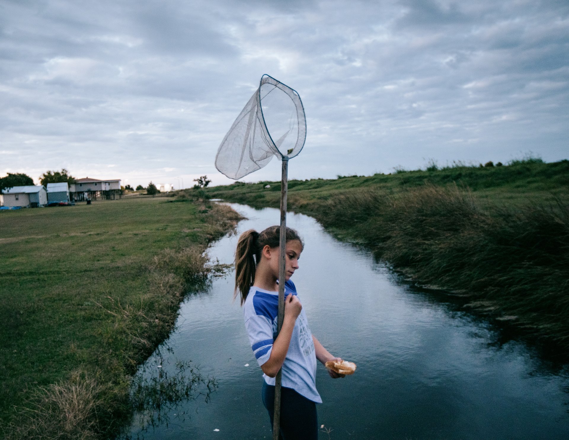 Hilton Chaisson&#39;s granddaughter, Isabella Chaisson, is the last teenager left on Isle de Jean-Charles. She and her father are waiting to be resettled in Gray. After school, she likes to play on the levees built to protect the island from flooding but which could not save them from Hurricane Ida. Isle de Jean-Charles, in Louisiana, United States.