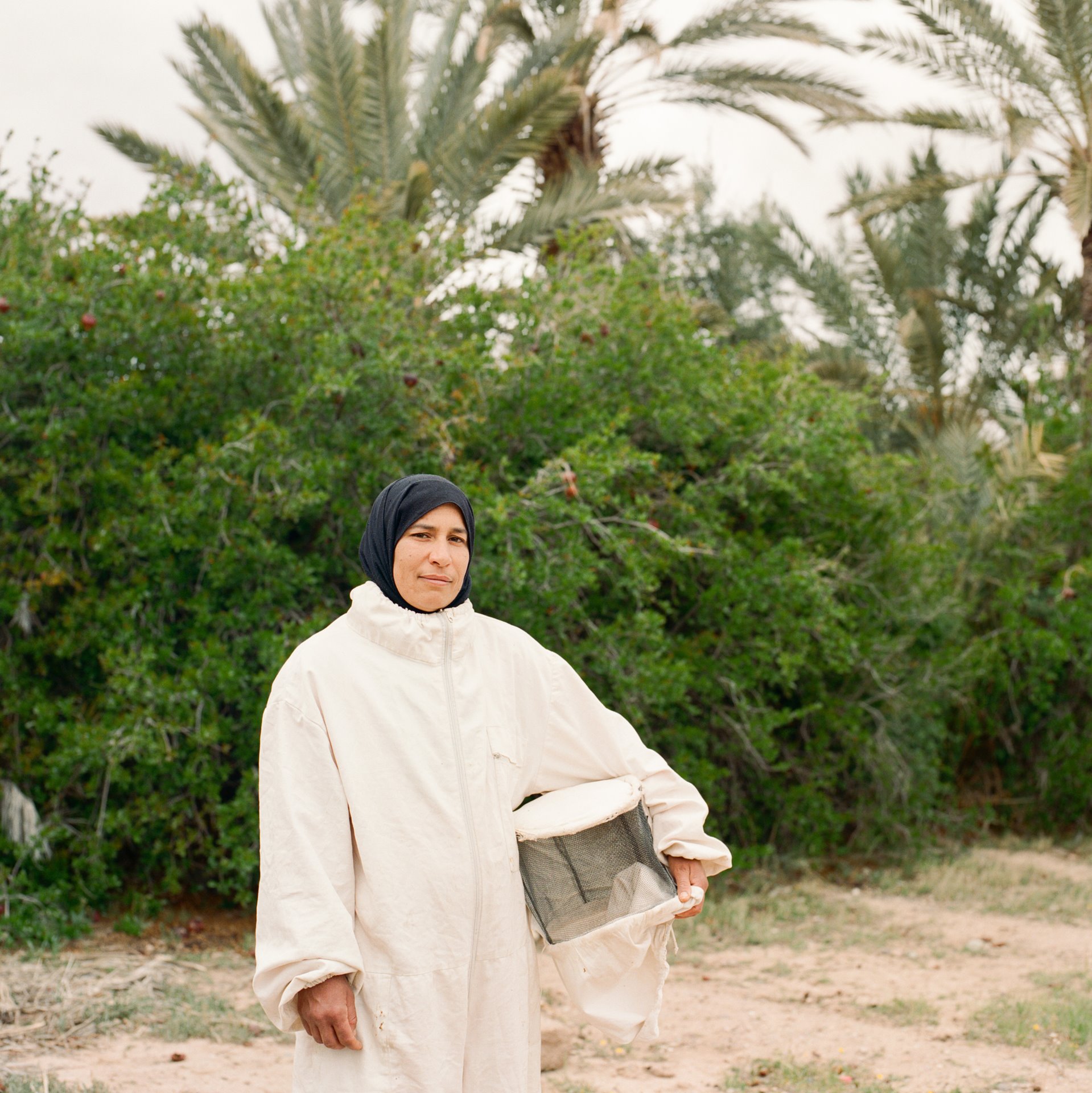 Zakia El Yamani (34) stands in her protective beekeeper&rsquo;s outfit, at Skoura Oasis, in central Morocco. She works to save the yellow Saharan bee. This millennia-old species is endemic to the oases of southern Morocco, but its population has dramatically declined following the use of pesticides against locusts in the 1980s, and the introduction of more aggressive Tellian black bees to the area.