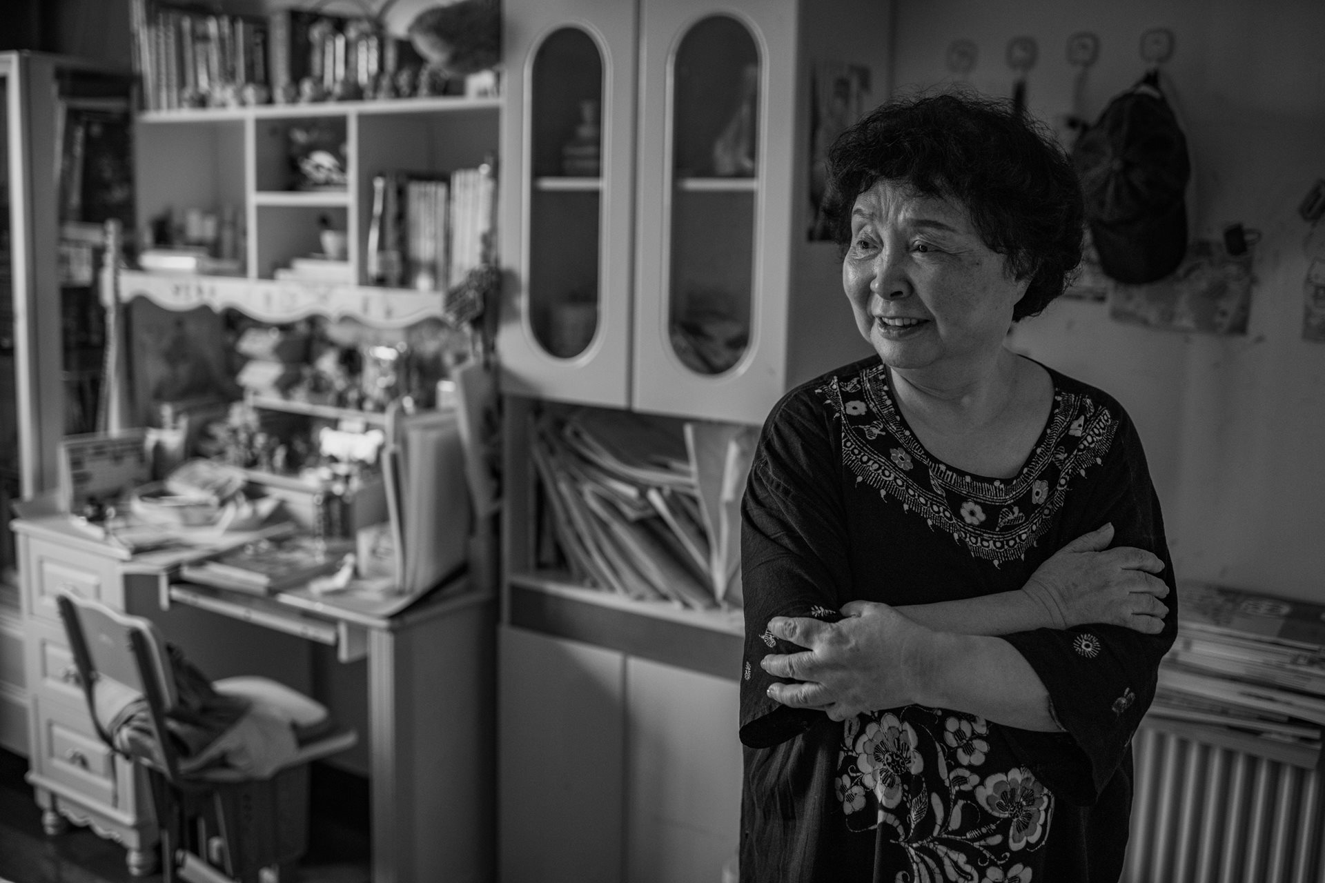 Sheng Hailin observes her daughters at home in Hefei, Anhui Province, China. Having reached 75, she has succeeded in raising them to the cusp of adulthood.&nbsp;