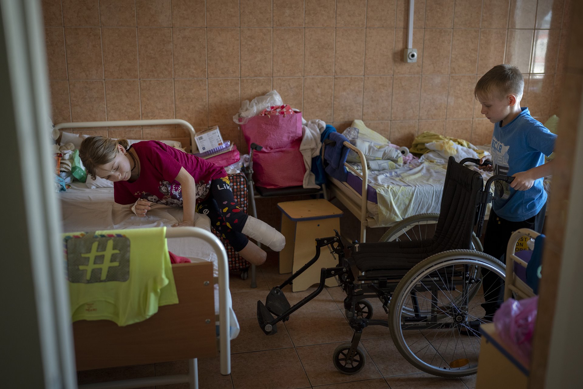 Yarik Stepanenko (11) helps his twin sister Yana, at a public hospital in Lviv, Ukraine. Yarik and Yana, together with their mother Natasha, were injured during shelling of a train station in the eastern city of Kramatorsk, on 8 April. According to the UN Human Rights Office, some 60 civilians were killed, and 110 wounded in a Russian missile strike on the station. Thousands of civilians were gathered there, awaiting evacuation. Russia denied involvement, claiming the strike was orchestrated by Ukraine. The family were later flown to San Diego, in the United States, where Yana and Natasha, who lost her left leg in the attack, received new prostheses, and Yarik underwent surgery.