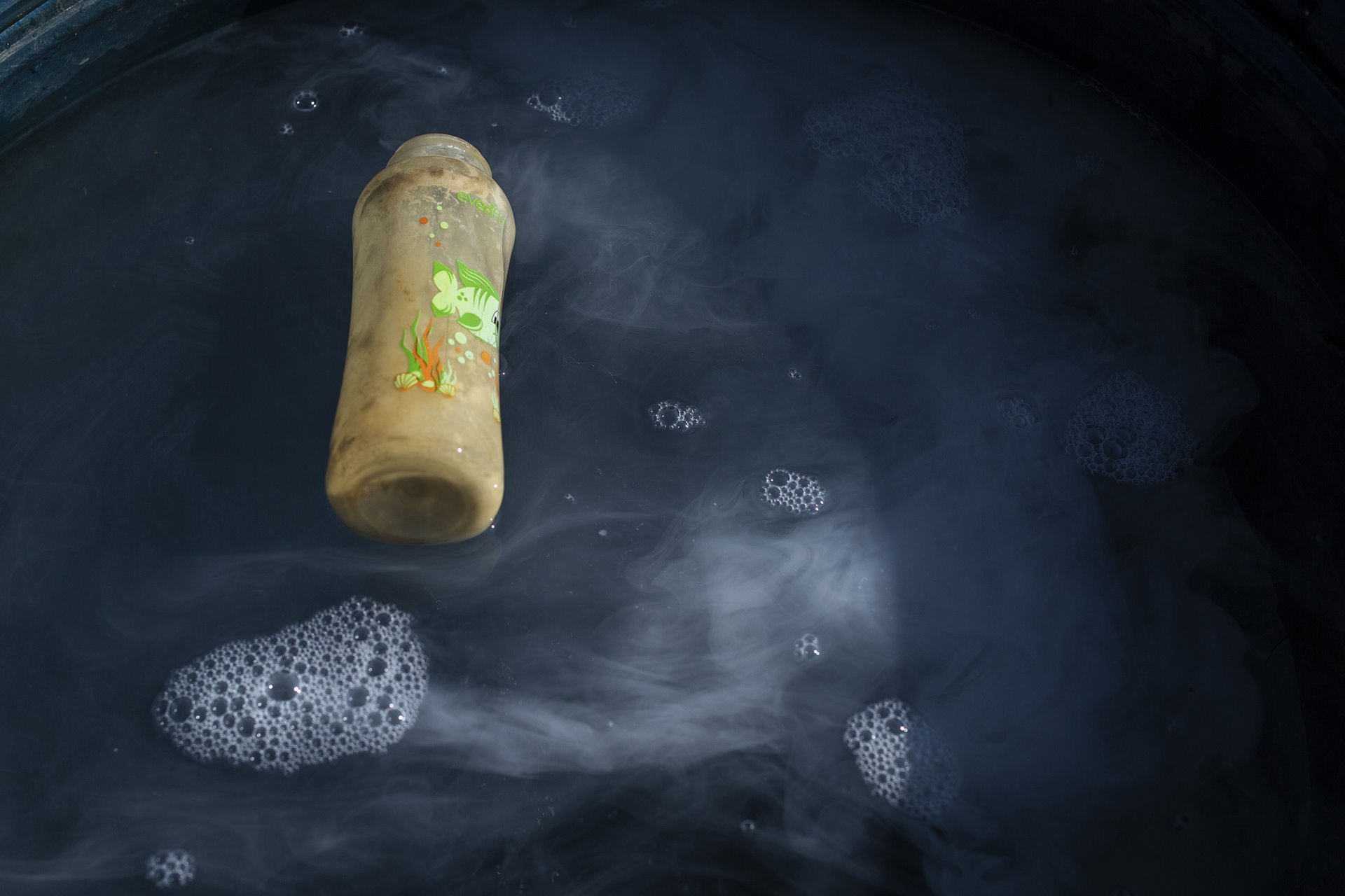 A baby&rsquo;s bottle used to measure agrichemicals floats in a drum of diluted pesticide about to be used to spray flower crops in Villa Guerrero, Mexico. Workers use the bottle because it has volume markings, which make measuring out the amount of chemical easier.&nbsp;