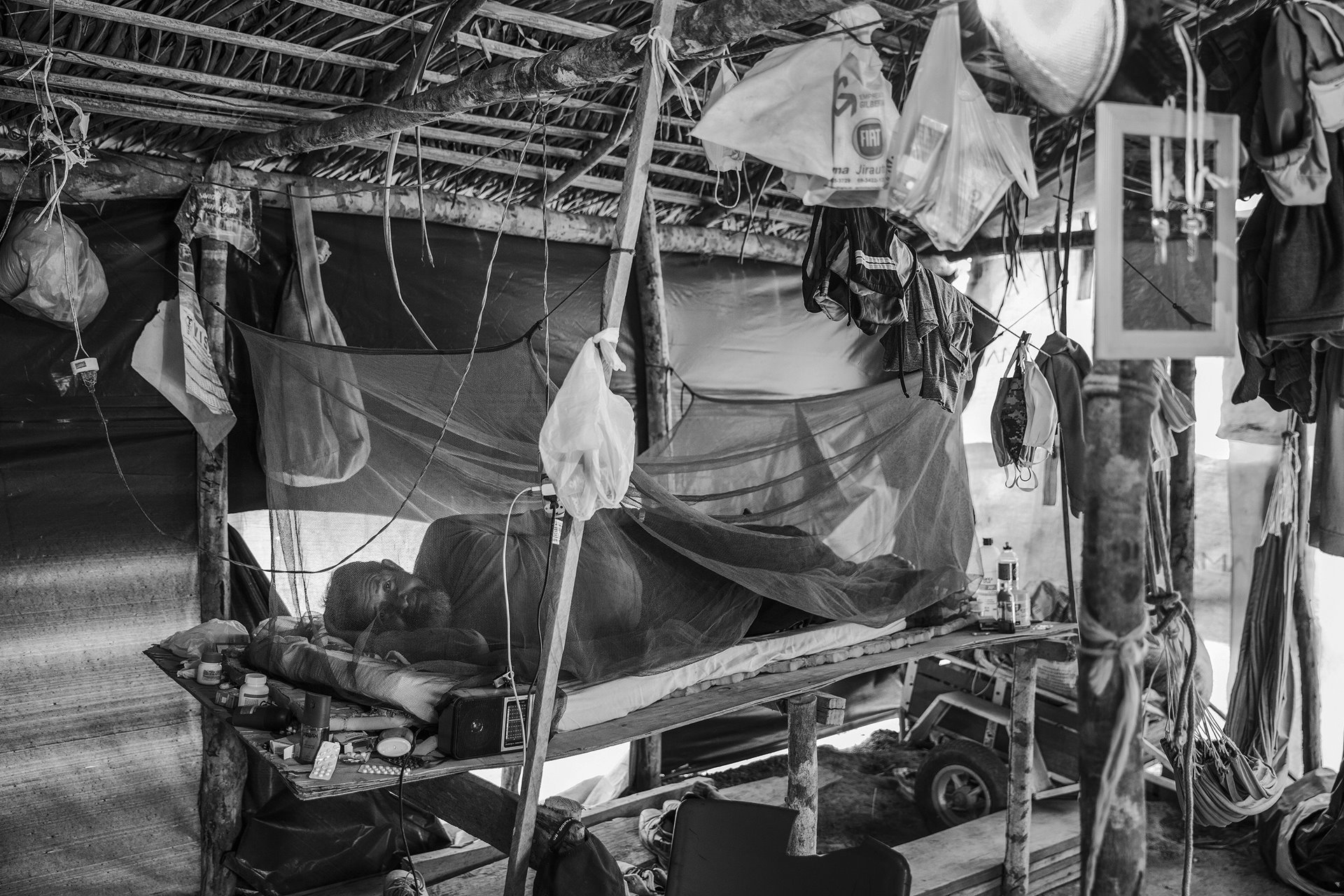 Sebastião Pereira rests in his shelter at a camp in the village of Rio Pardo, in Rondônia, in the Brazilian Amazon. This camp was set up by families who had been evicted from an invaded area inside the Bom Futuro National Forest.