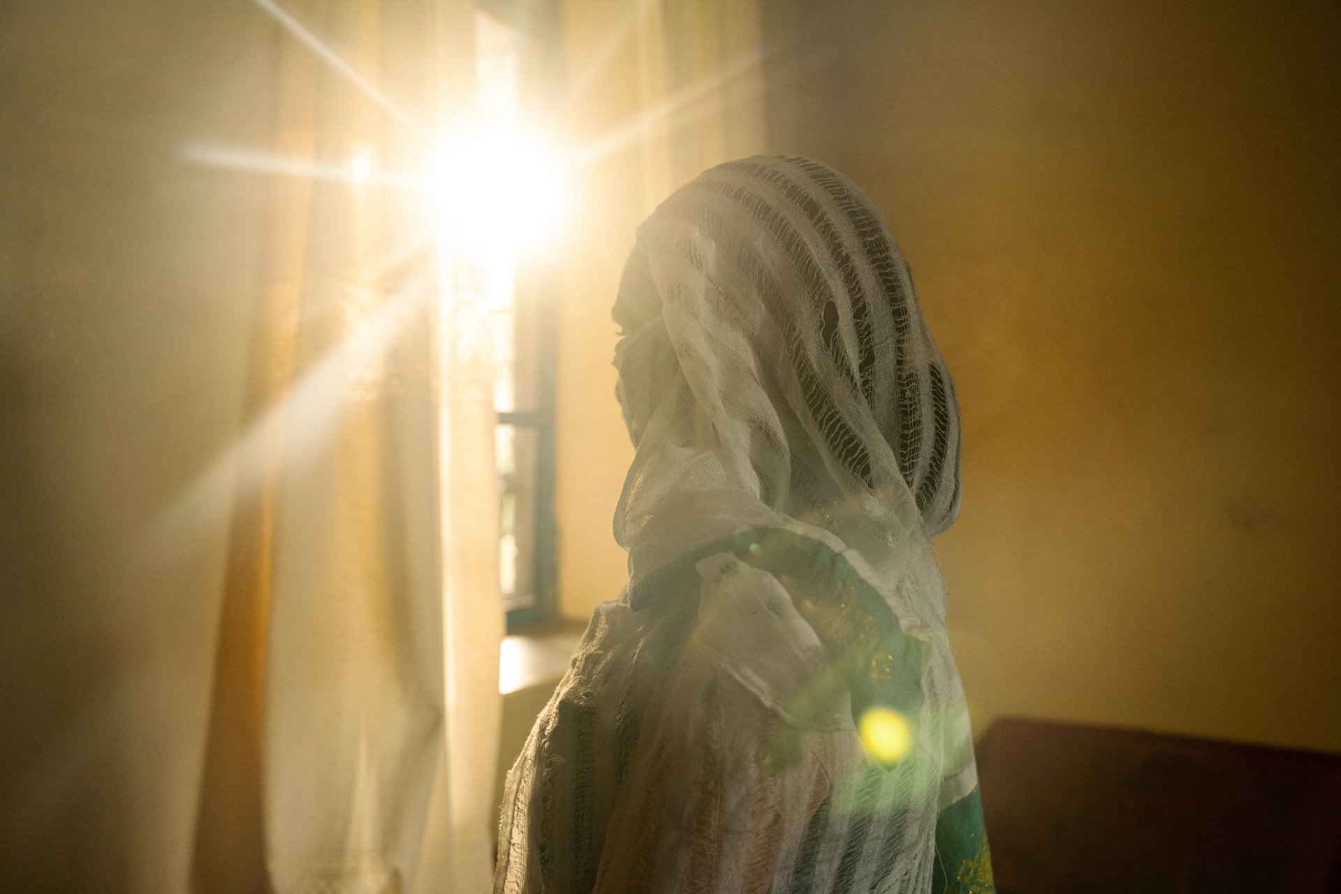 A 25-year-old survivor of sexual violence photographed in Mekele, Ethiopia. She was repeatedly raped by Eritrean and Amhara forces in the southern region of Raya Azebo over three days. When she visits her family, she hides her face and avoids walking in public. Even though she knows her mother was also raped, she remains too ashamed to disclose her own assault to her mother. Counseling has helped her with the shame, pain, and rage she has felt ever since her assault.