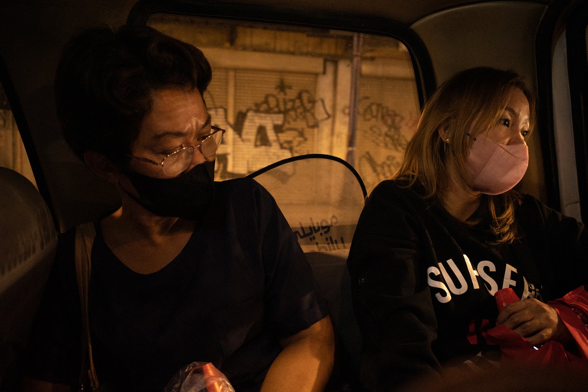 Mary Anne Domingo and Sharon Angeles make their way home from selling coffee and cookies at a theater venue in Manila, the Philippines. Both lost loved ones to the war on drugs and have been active in seeking justice for their families. One of the performances that night touched on the war on drugs and they were invited in to watch it.