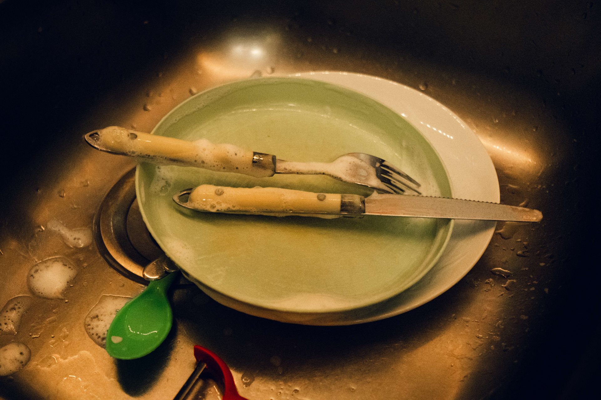 Washing dishes for others is part of Ana Maria&rsquo;s workday routine, in Lisbon, Portugal.