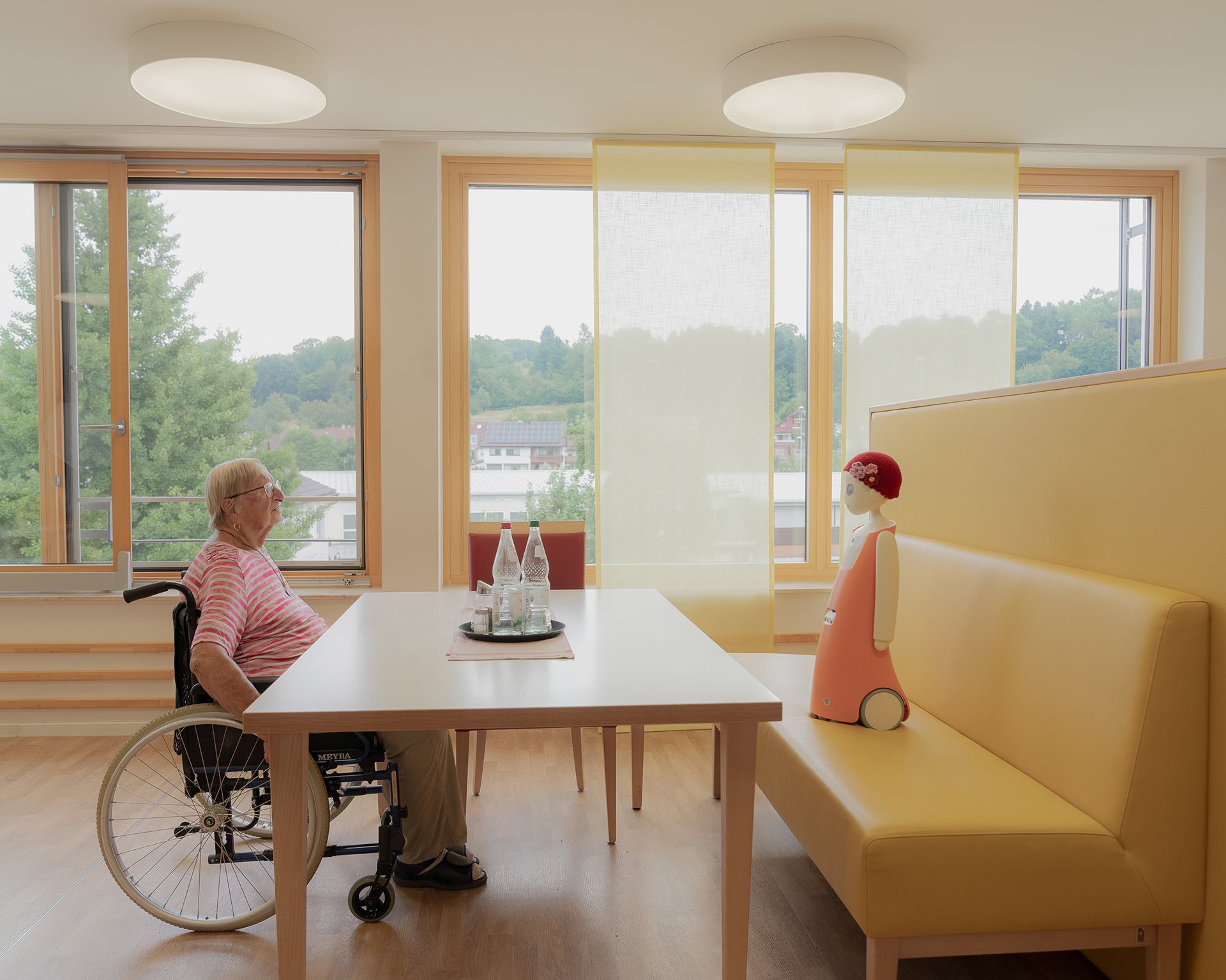 Waltraud talks with Emma, a social robot that recognizes faces and remembers past conversations. Though skeptical at first, Waltraud says she felt connected to Emma over time. Albershausen, Germany.