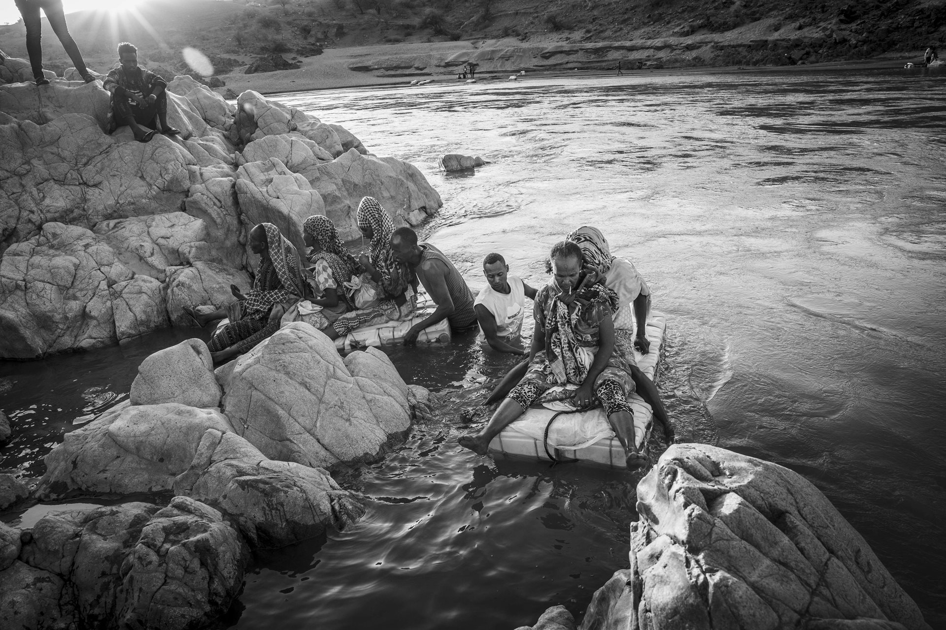Ethiopian women navigate the Tekezé River, Humera border, Ethiopia. The 2018 peace deal between Eritrea and Ethiopia offered hope, opening the border for Ethiopians to cross into Eritrea. However, for many, this was an &ldquo;external peace&rdquo; brought about by geopolitical pressure, and border restrictions and human rights violations persist, forcing many to risk dangerous crossings with the aid of traffickers on the Tekezé River.