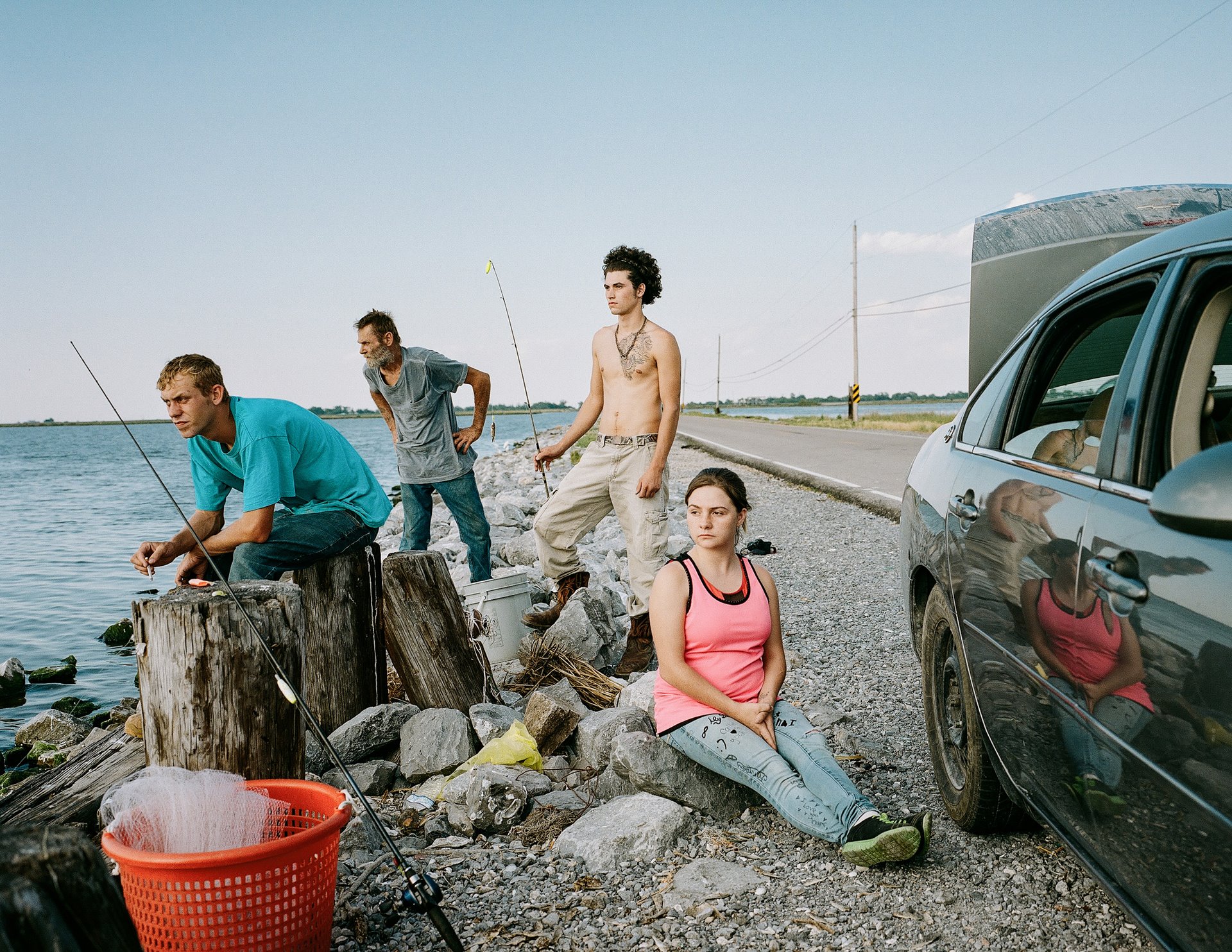 Many families fish off Island Road, the only thoroughfare connecting Isle de Jean-Charles to the mainland, after work or on weekends. During high tide and hurricanes, the road can be submerged under water. Isle de Jean-Charles, Louisiana, United States.