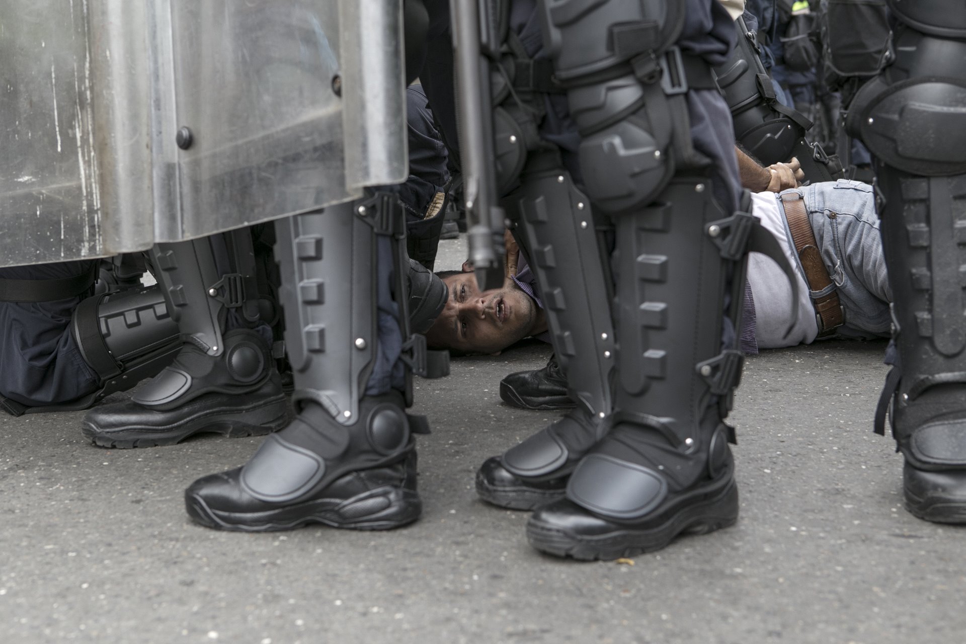 <p>Police arrest a man during a protest rally calling for the removal of President Nicolás Maduro from office, in Caracas, Venezuela.<br />
<br />
Nicolás Maduro, Hugo Chávez&rsquo;s chosen successor, was elected president by a narrow margin in 2013, but opposition parties contested the result. Protests, contested elections, and accusations of vote-rigging continued throughout the years that followed, with opponents of Maduro blaming him for Venezuela&#39;s economic crisis.&nbsp;</p>
