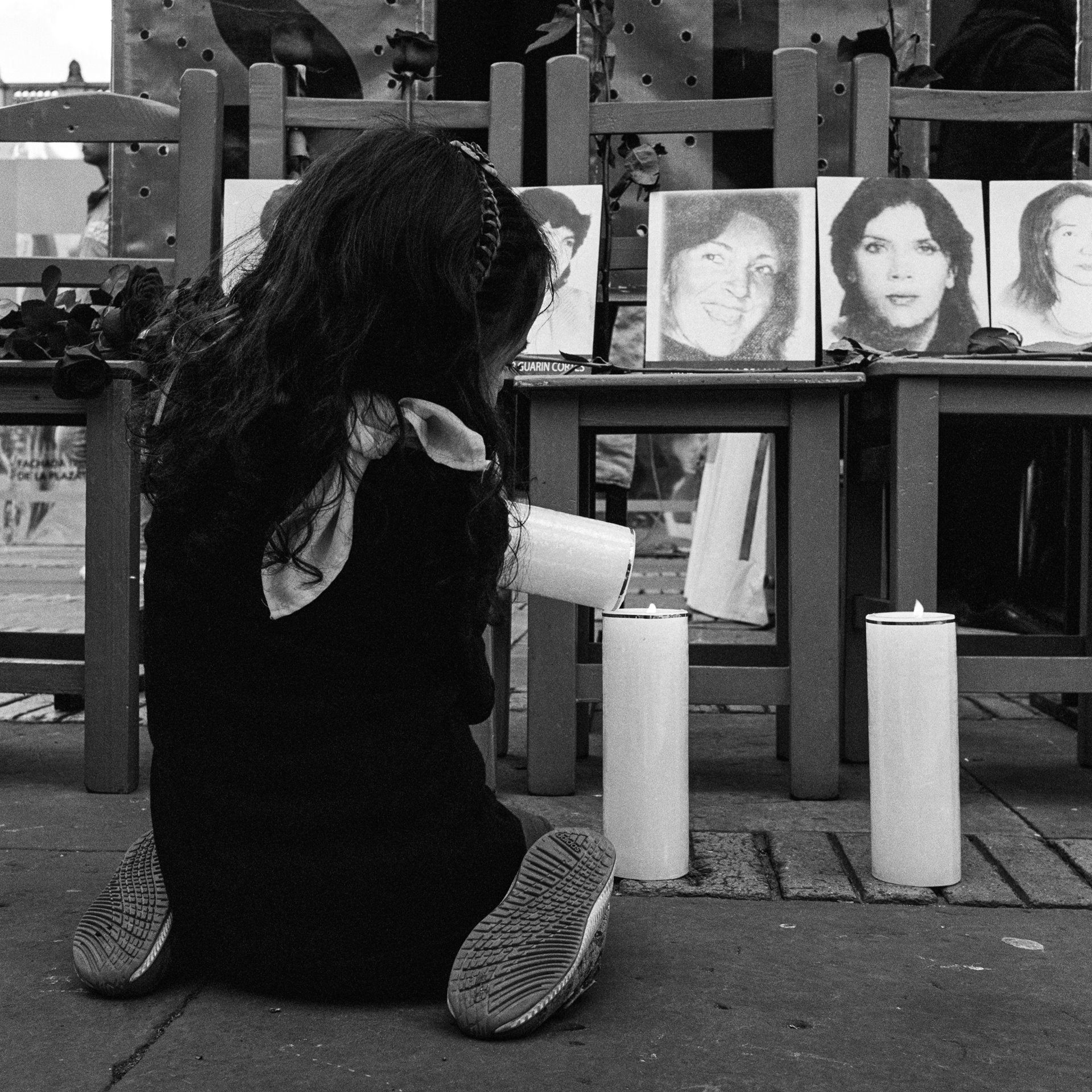 Samantha, granddaughter of Ana Rosa Castiblanco, lights candles during a protest on the 35th anniversary of the siege of the Palace of Justice in Bogotá, Colombia. Ana Rosa, a kitchen assistant at the Palace of Justice, disappeared during the 1985 siege of the Palace, when she was 32 and pregnant. Her remains were returned to her family in 2017.