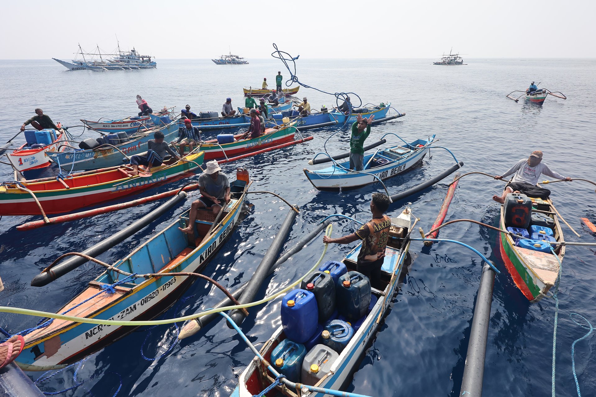 Filipino fishermen dock their boats beside a government supply ship distributing oil and food, near Scarborough Shoal, off Zambales province, Philippines.&nbsp;<br />
&nbsp;