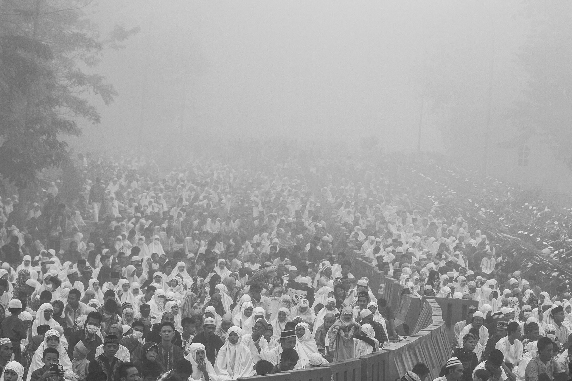 <p>People gather during the Muslim festival of Eid al-Adha in Palembang, Indonesia. Smog from forest fires had pushed air quality to unhealthy levels, prompting the cancellation of flights and warnings for people to stay indoors.</p>
