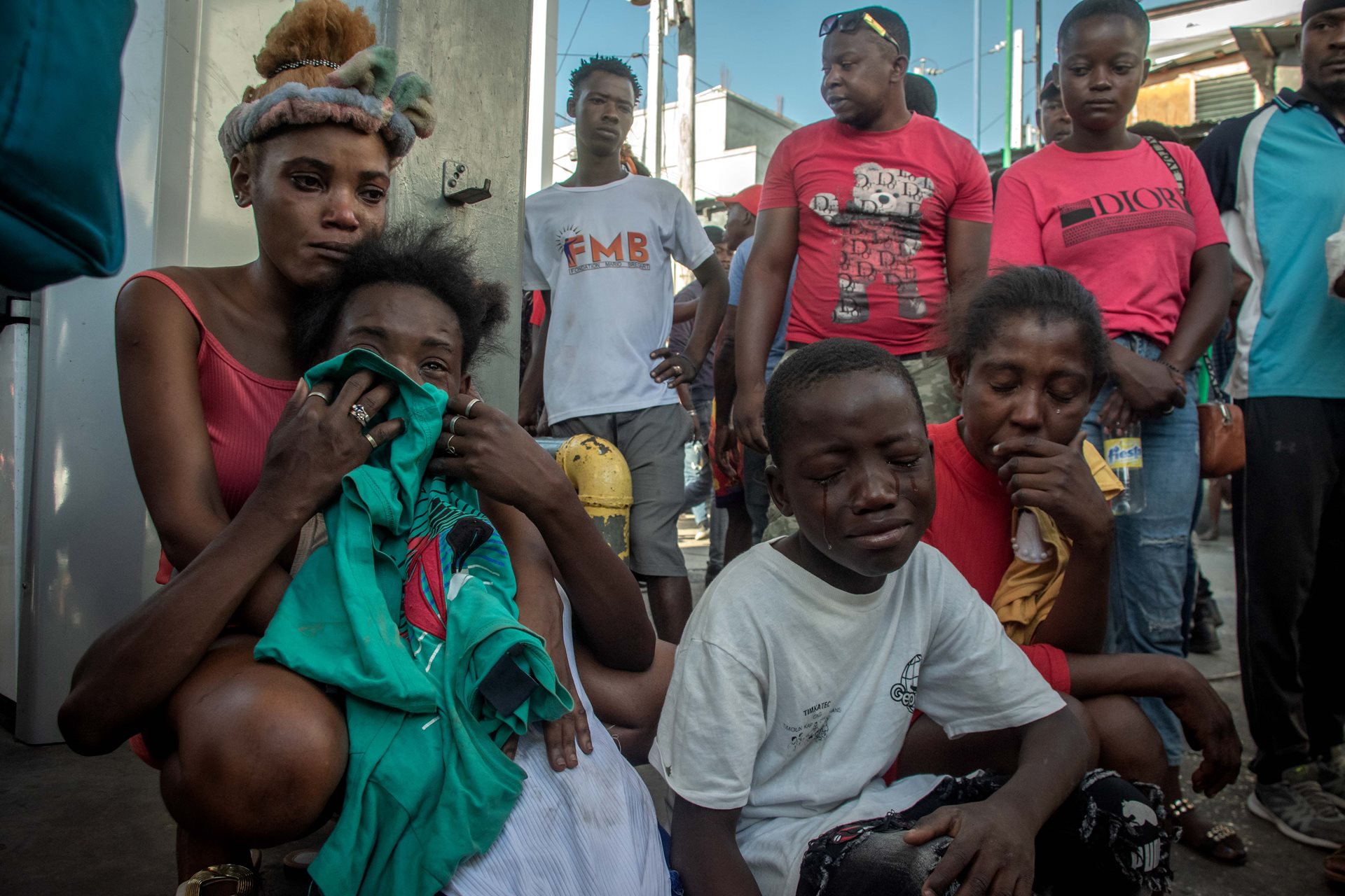 People grieving after learning that their family members were among a dozen people shot and killed by an armed gang, in Pétion-Ville, Port-au-Prince, Haiti.