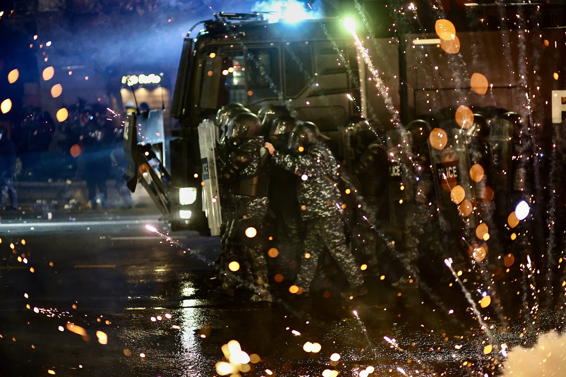 Protesters throw fireworks at riot police, at an anti-government rally in Tbilisi, Georgia.