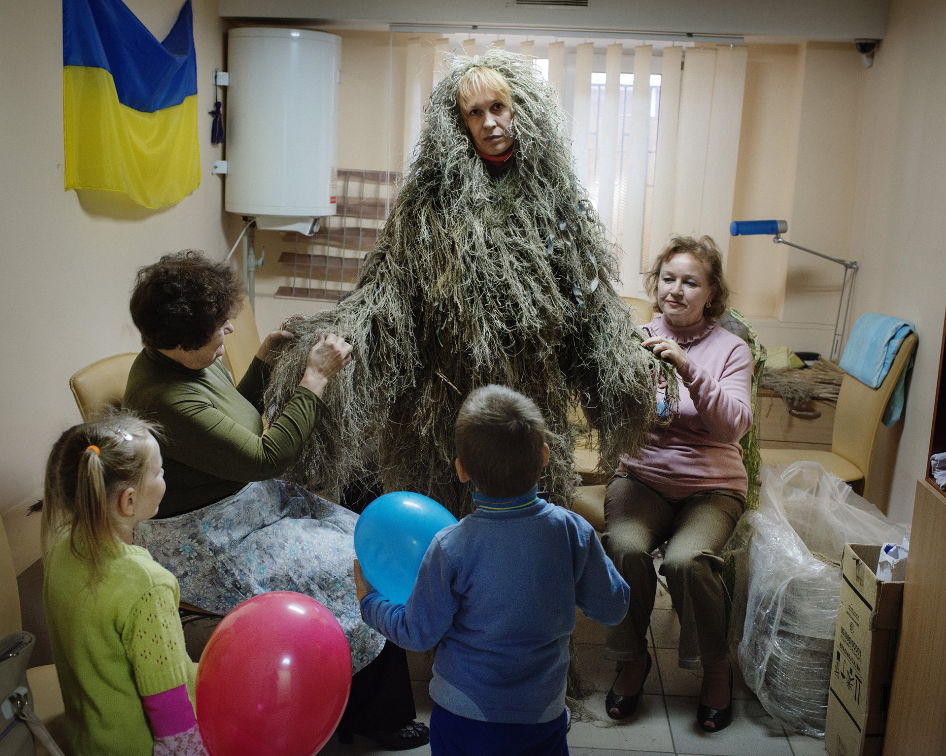 Women make camouflage gear for snipers, at the Novy Mariupol Center, an organization that collects equipment for Ukrainian soldiers, in Mariupol, Ukraine.
