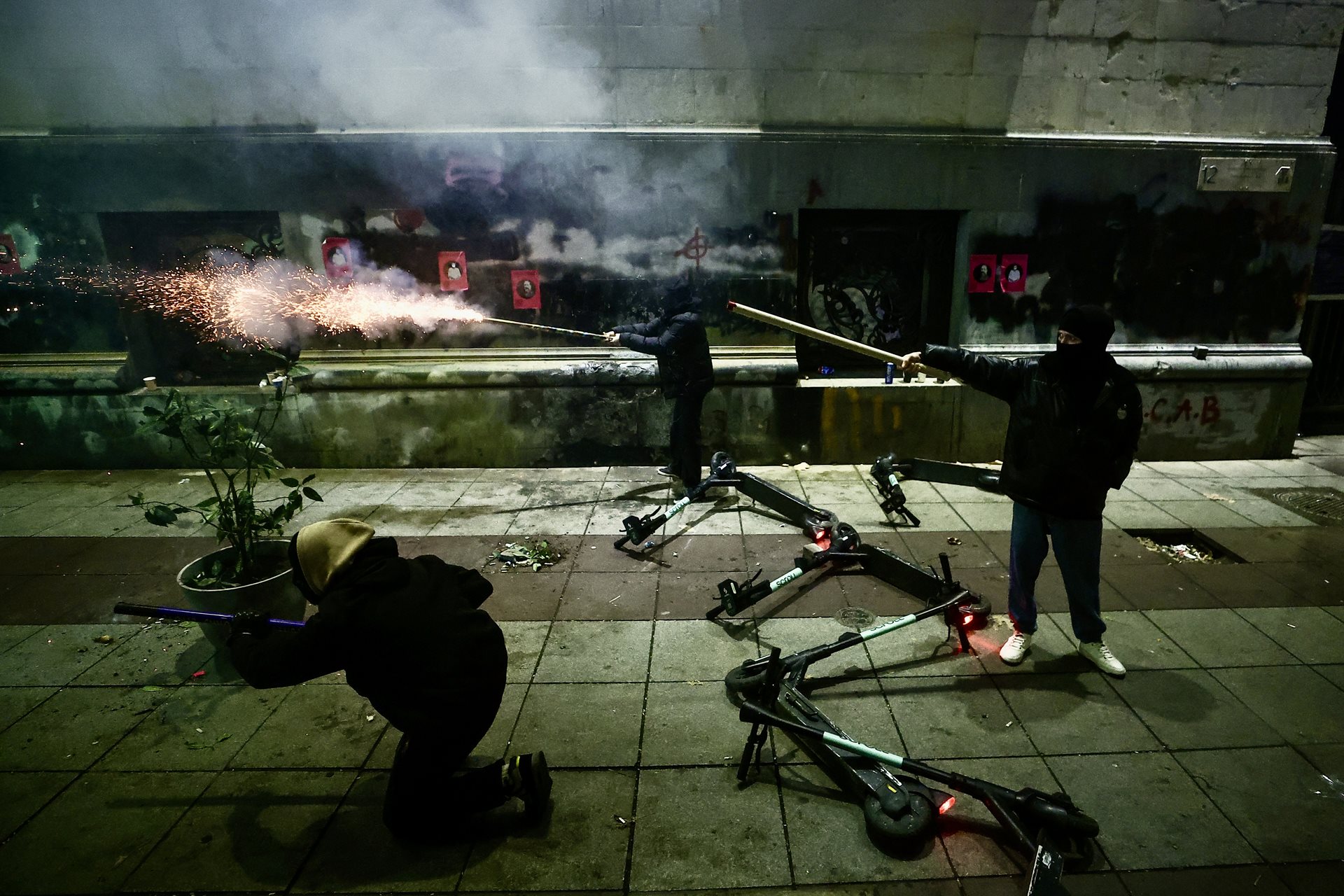 Protesters shoot off fireworks in response to tear gas fired by riot police, during a rally outside the parliament building on Rustaveli Avenue, in Tbilisi, Georgia.