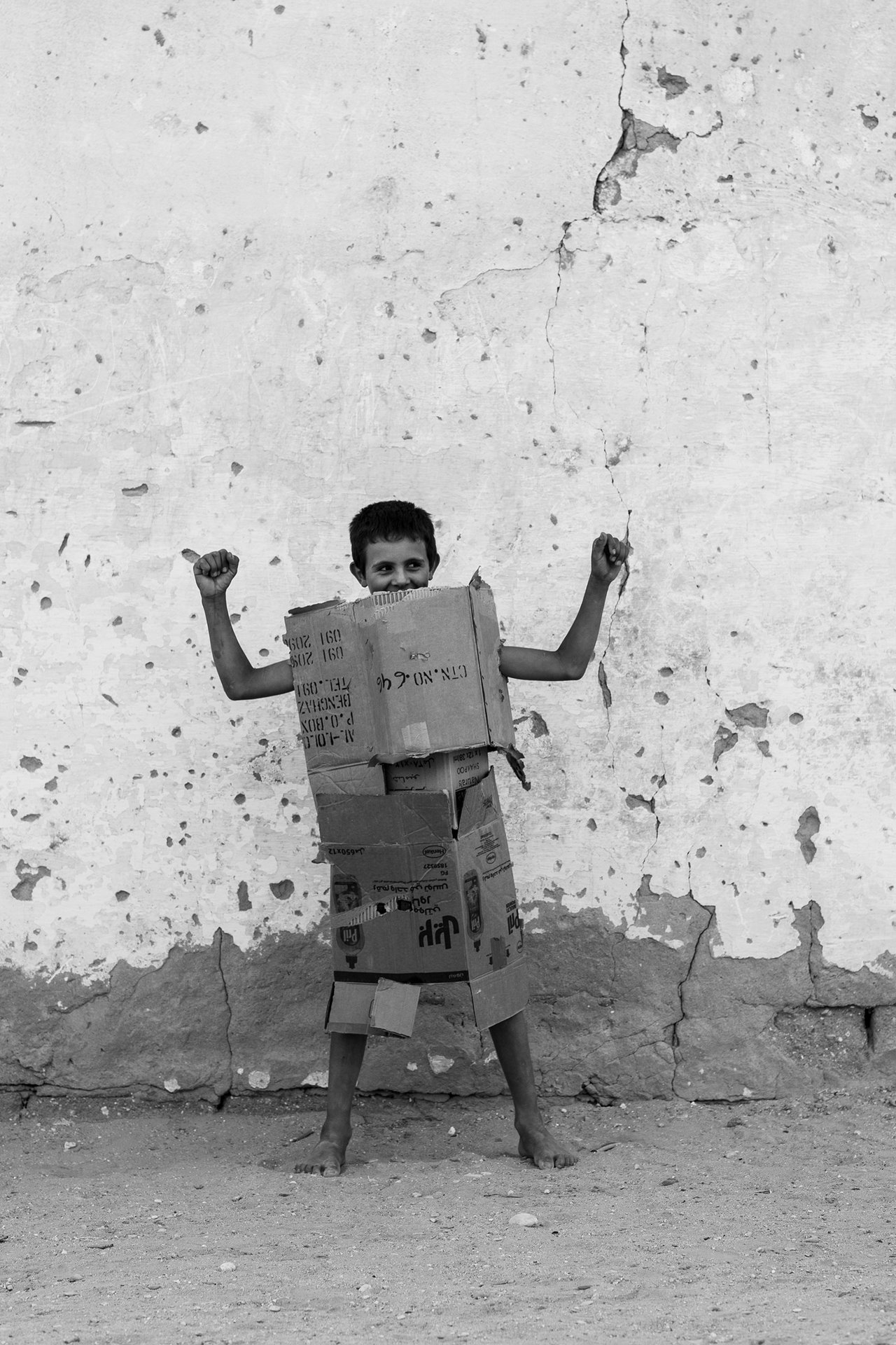A boy plays in a cardboard suit of armor, in Mdhilla, Tunisia.&nbsp;