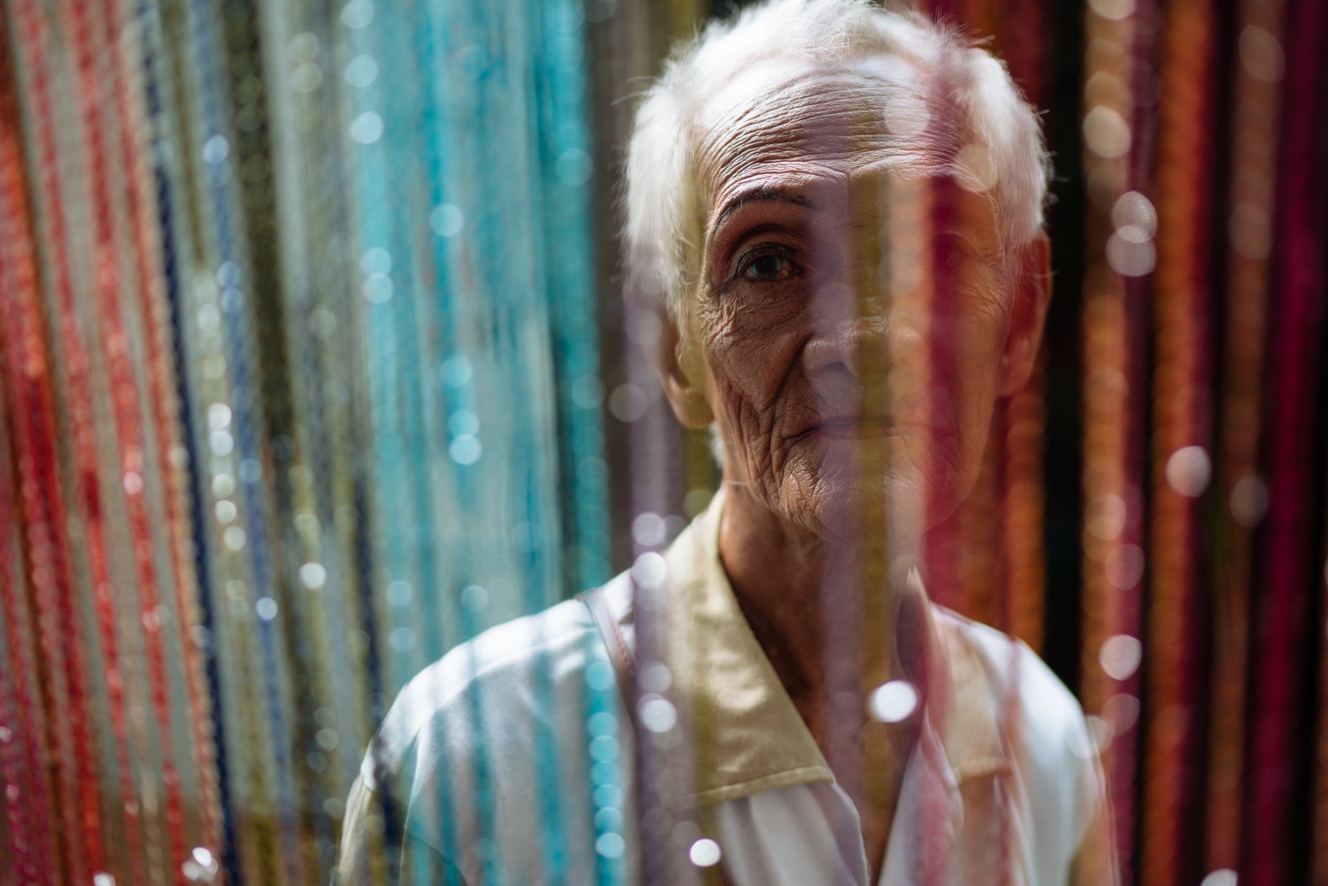 <p>Al Enriquez (86) looks through a curtain in the the Golden Gays&rsquo; home in Manila, the Philippines.&nbsp;</p>
