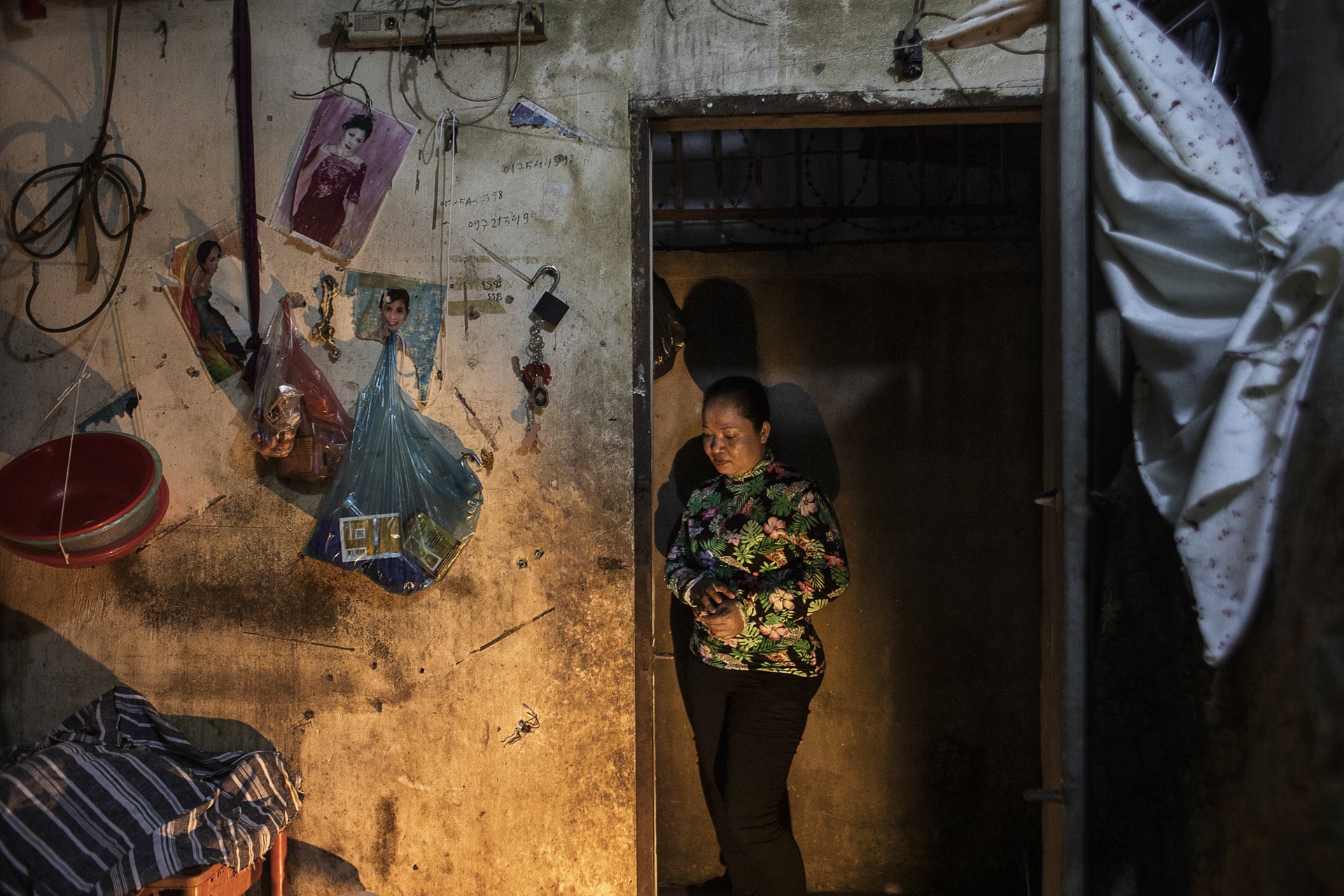 Sopha (35) lives in a small, cubicle-like room with fellow factory workers in a busy neighborhood in Phnom Penh, Cambodia. She works overtime to send money home to her two biological children and one surrogate son, who are being raised by her mother in her home village. As a victim of gender-based violence who is divorced from her husband, Sopha turned to surrogacy to try to buy her husband out of the house they owned so she could cut ties. Instead she was arrested and taken to a military hospital where she gave birth to her surrogate son.&nbsp;