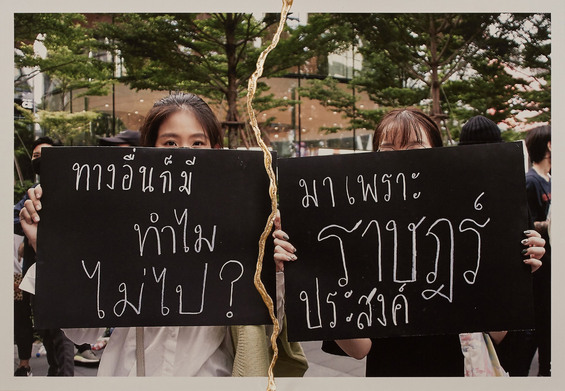 Protesters hold signs during a demonstration in Bangkok, Thailand.&nbsp;<br />
<br />
The signs say &ldquo;There is another way, why not go?&rdquo; (L) and &ldquo;Come because the people wish it&rdquo; (R).
