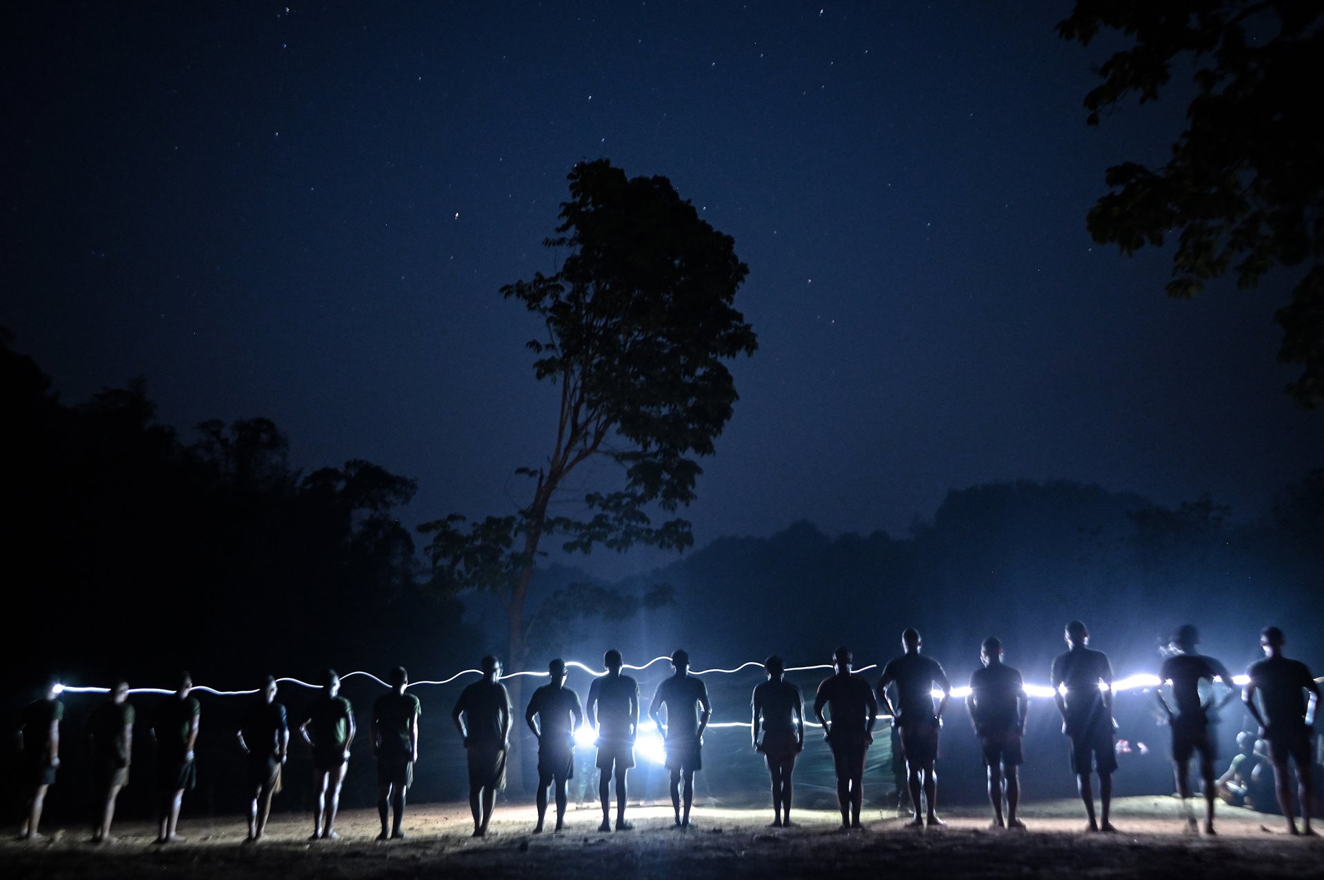 New recruits to anti-junta forces undergo night combat training in a jungle training camp in Kayin State, Myanmar, near the Thailand-Myanmar border. The PDF experienced a surge in volunteers in reaction to national military conscription enacted in February 2024, and many young people fled to neighboring countries.