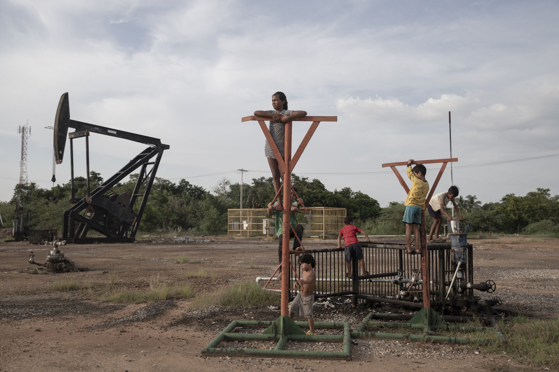 Children play on abandoned oil structures in Cabimas, on the shores of Lake Maracaibo, Zulia State, Venezuela. Crude oil and other pollutants spill into the lake, in which the children swim, from badly maintained equipment owned by state oil company PDVSA. Between 2010 and 2016, the company was responsible for more than 46,000 spills of crude and other pollutants, according to a study by PROVEA, a Caracas-based human rights group. PDVSA stopped releasing data in 2016, reporting 8,250 oil spills that year.