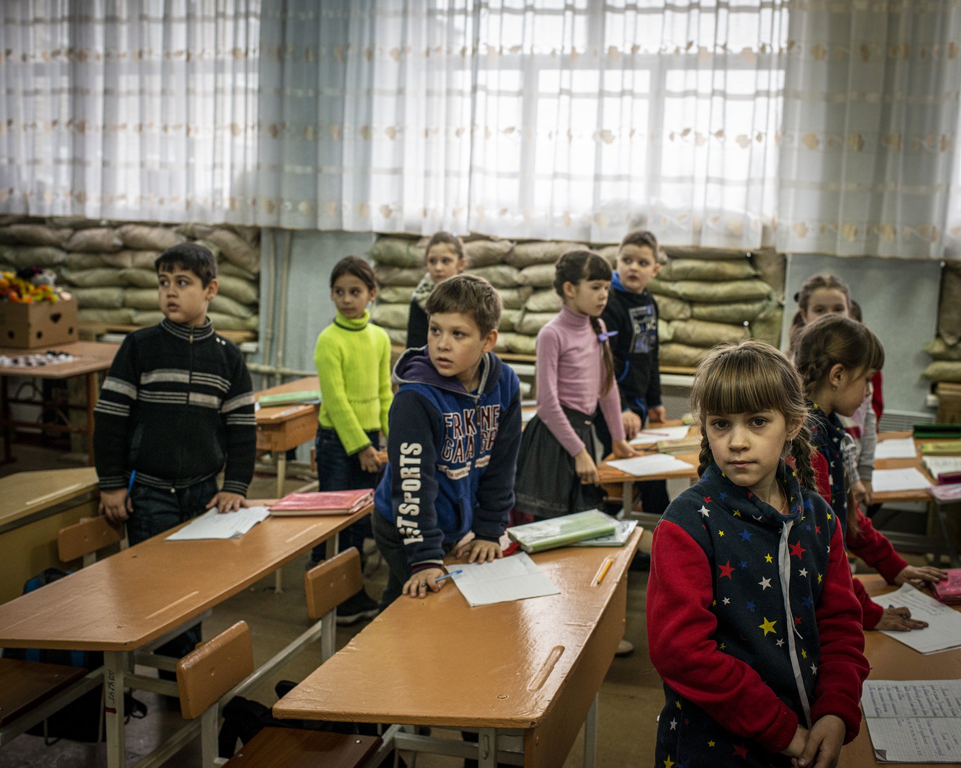 Students stand in a classroom of No. 2 school in Lenin Square, in Marinka, Donbas, Ukraine. The school remained open through the ongoing conflict between separatists and Ukraine government forces in the region.