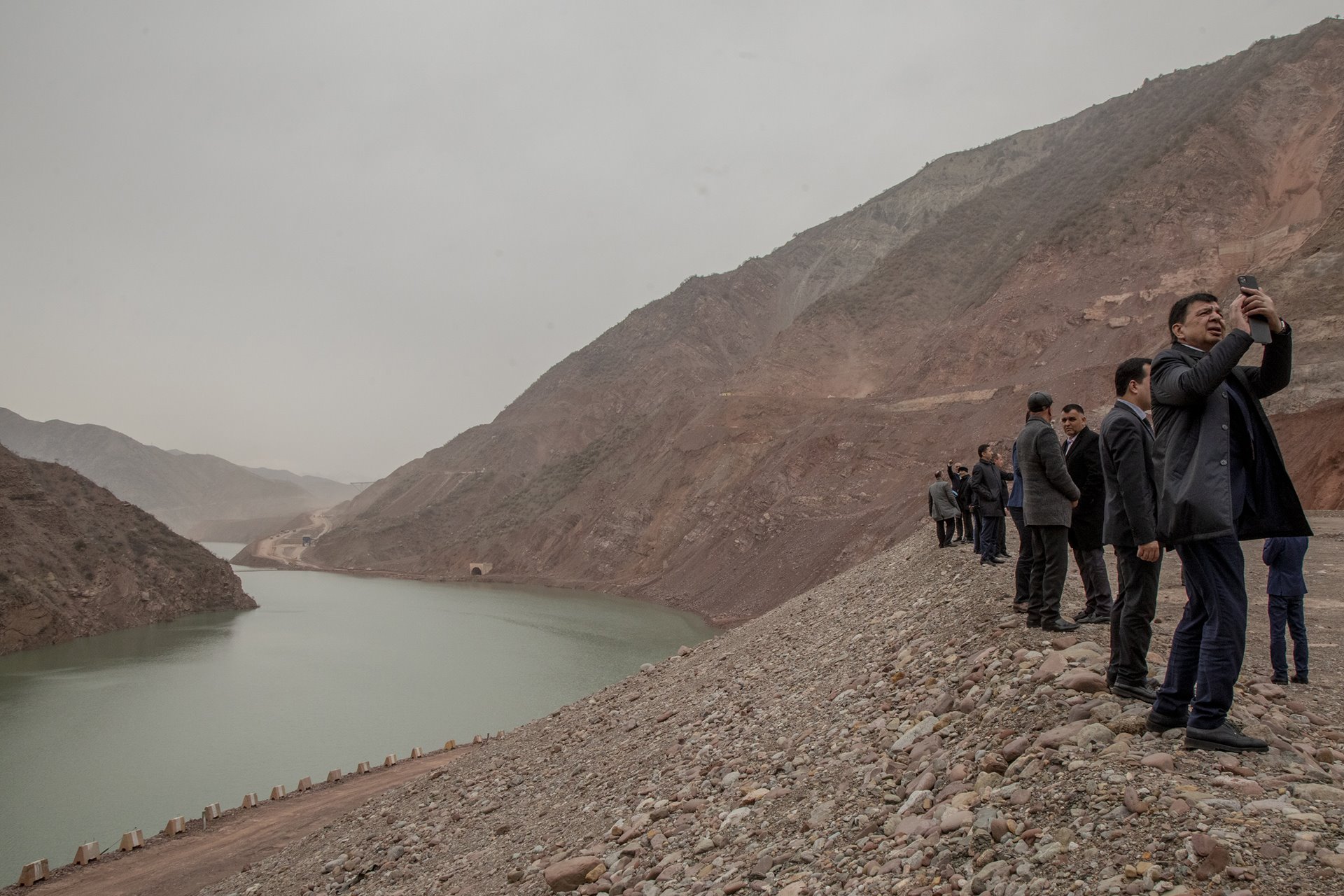 <p>Visitors photograph the Rogun Dam, being built in eastern Tajikistan to provide hydroelectric power. The 335-meter-high dam is due for completion in 2028-2029.</p>
