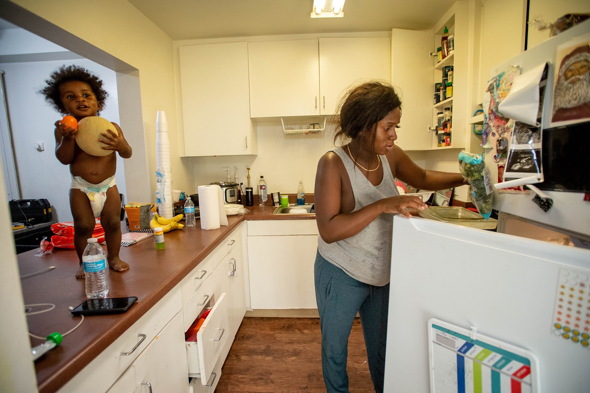 Aysha makes her son a snack at home in downtown Los Angeles, USA. Aysha&rsquo;s midwife talked about a diet with more fresh fruit and vegetables for the whole family during a prenatal visit.