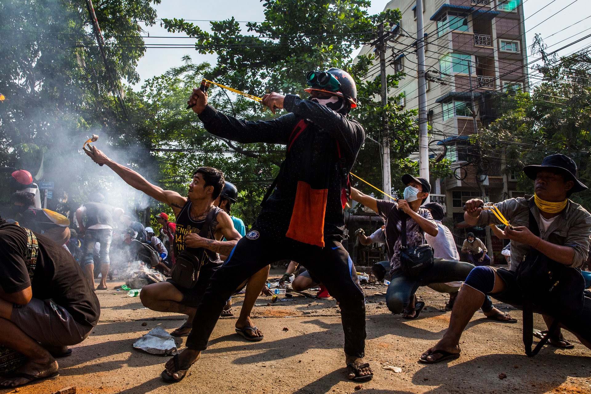 <p>Protesters use slingshots and other homemade weapons in a clash with security forces in Yangon, Myanmar.</p>
