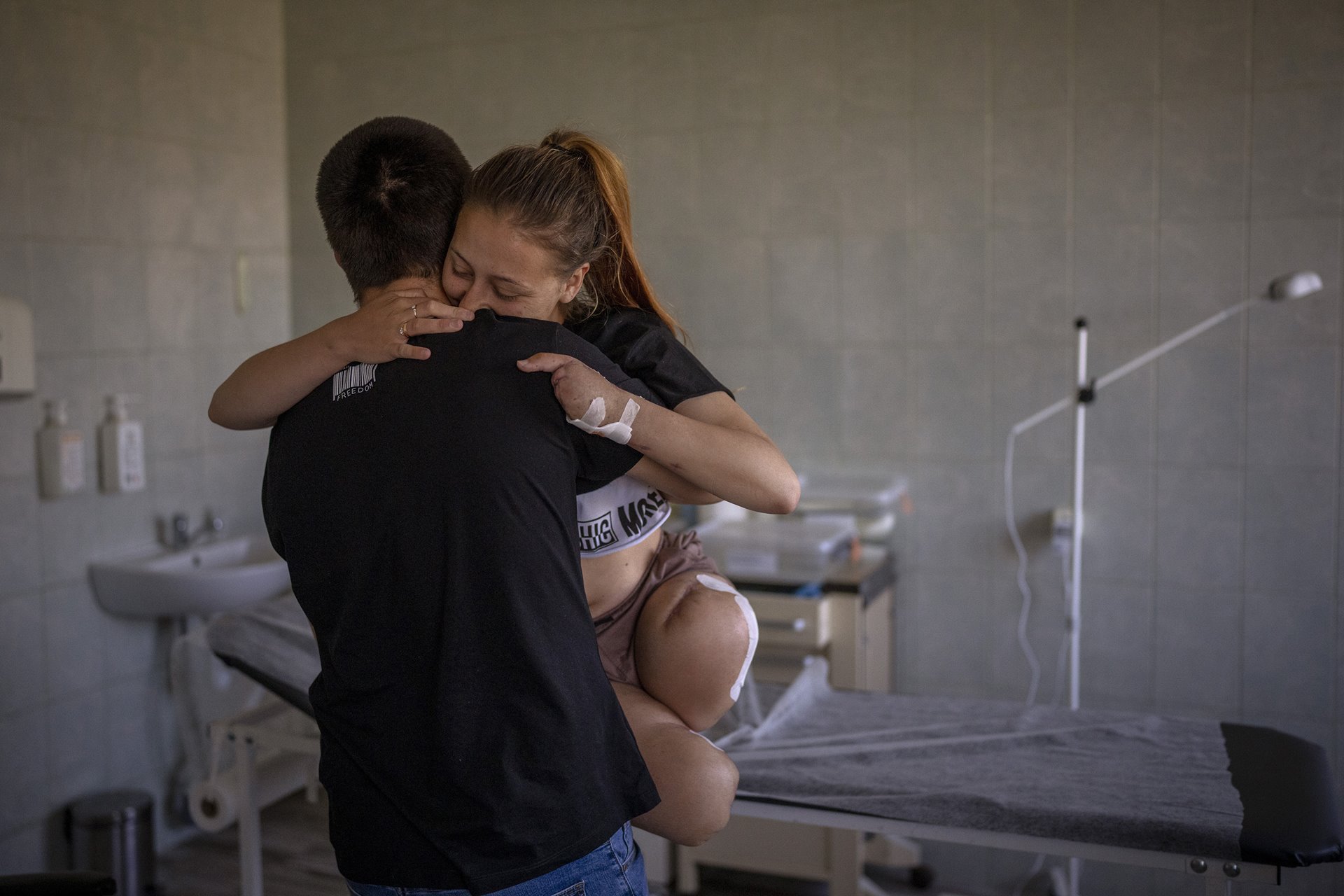 <p>Viktor (23) carries his wife Oksana Balandina (23) in a Lviv hospital. The couple married while Oksana was in hospital, and Viktor carried her like this for their first dance. Oksana was injured by an explosion near her home on 27 March. She went to Germany for rehabilitation and to receive prosthetics, and later returned to Ukraine.</p>
