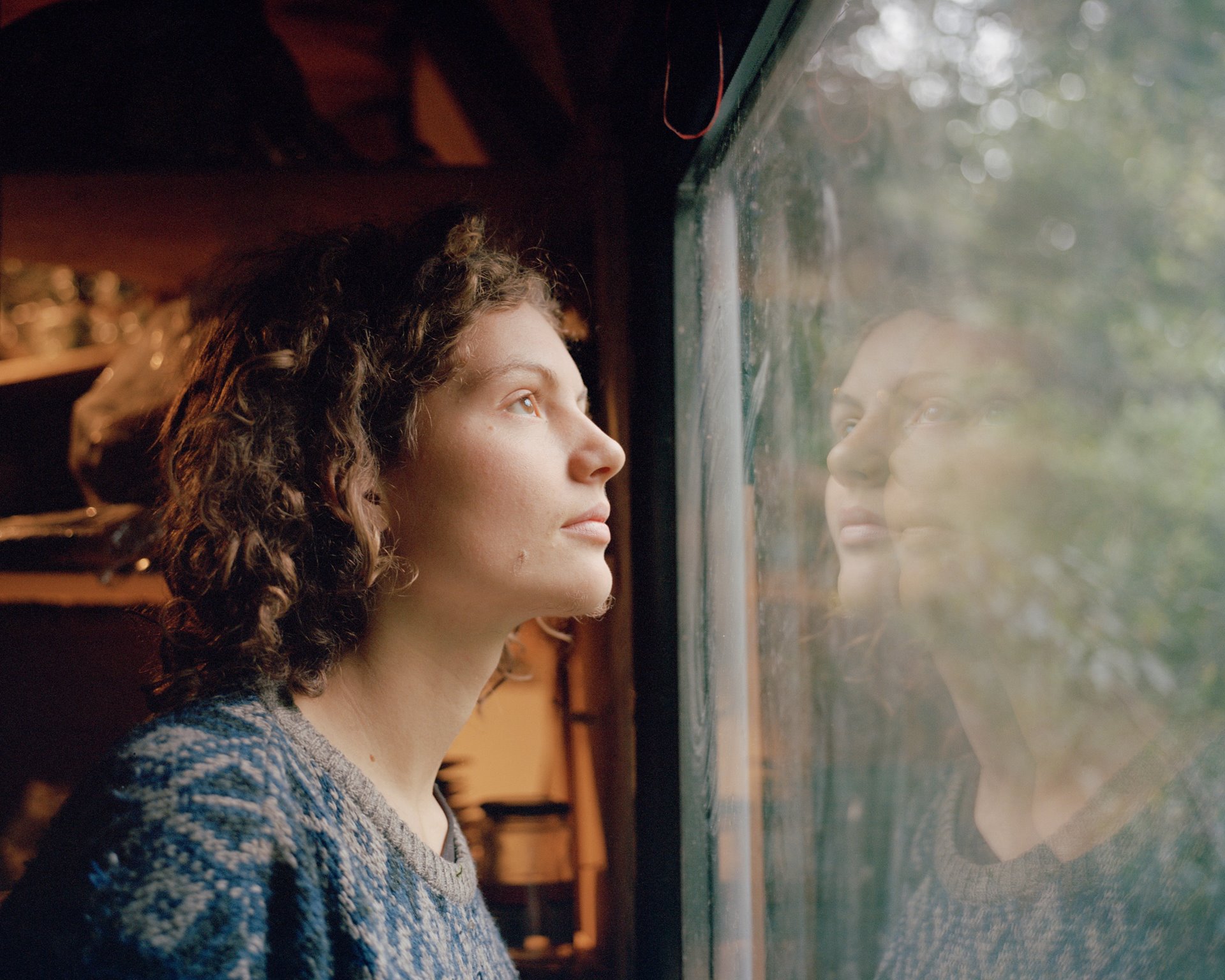 &quot;Indigo&quot; looks out of a window of a treehouse in Gallien, the largest treehouse settlement in the Hambach Forest, near Kerpen, Germany. Activists in the forest use assumed names as they fear police reprisals.