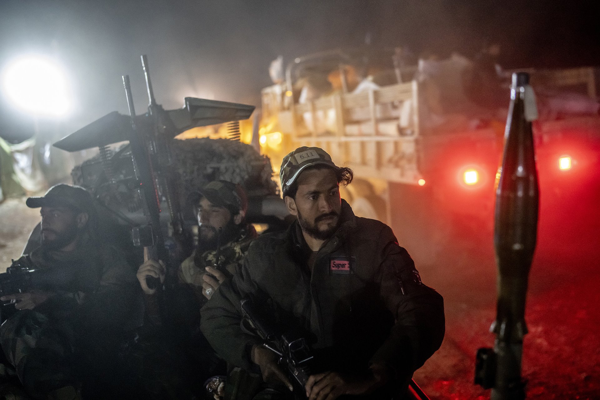 Taliban fighters patrol as Afghans recently deported from Pakistan arrive at a camp in Torkham, Afghanistan, near the Pakistan-Afghanistan border. Around 490,000 refugees crossed the border in the weeks around the Pakistan government&rsquo;s 1 November deadline for the deportation of undocumented Afghans from the country.&nbsp;