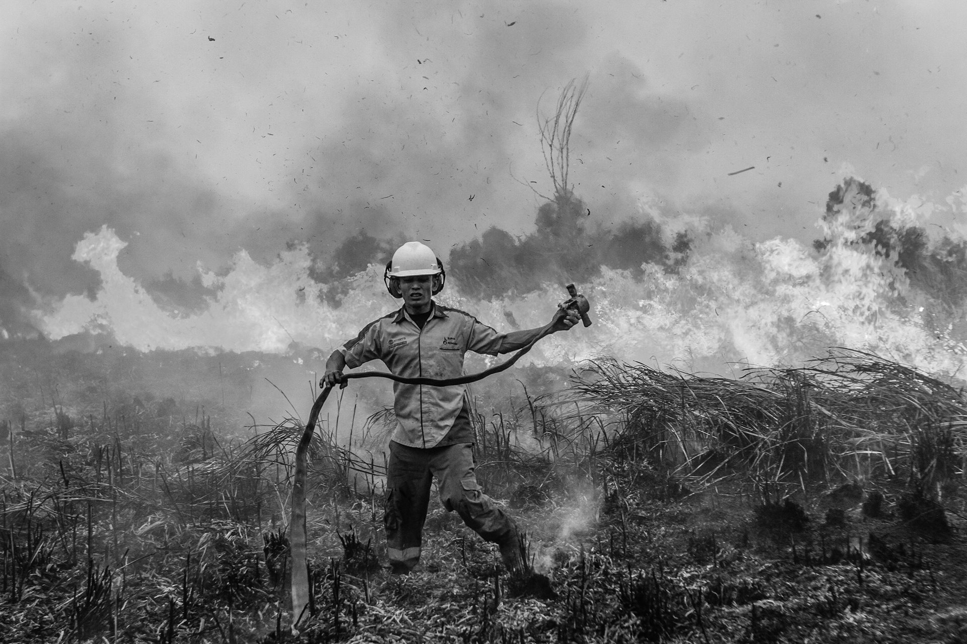 A firefighter combats a wildfire in Ogan Komering Ilir, in South Sumatra, Indonesia.
