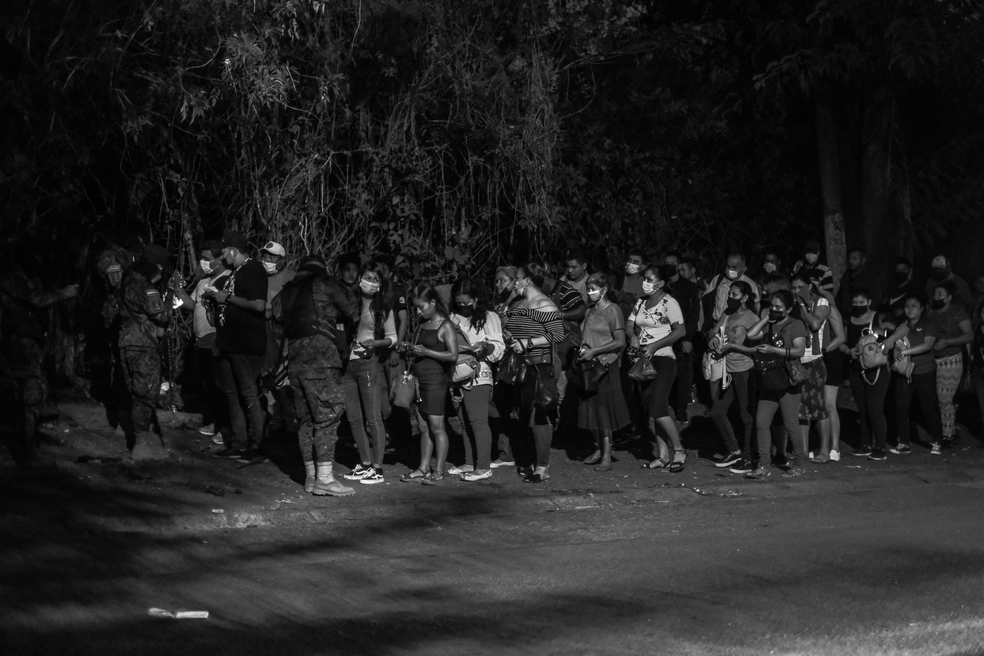 People line up to show their IDs at a police checkpoint in Distrito Italia, a dangerous neighborhood in El Salvador where many gang members live, during the first days of the &ldquo;state of emergency.&rdquo; Tonacatepeque, San Salvador, El Salvador.