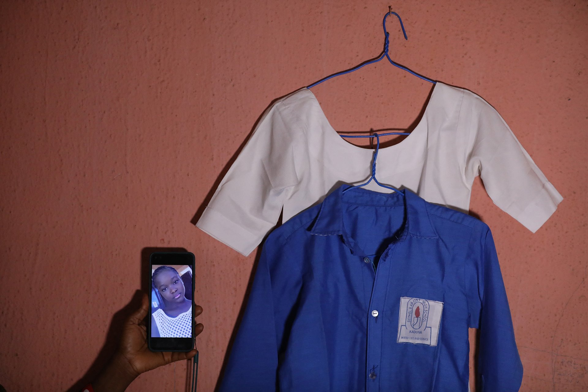 <p>Hawa Munzali (not her real name) displays a photo of her 14-year-old daughter Faith (not her real name), who was among 140 students abducted from the Bethel Baptist High School, in Chikun, Kaduna State, northwest Nigeria, ten days earlier, on 5 July 2021.</p>
