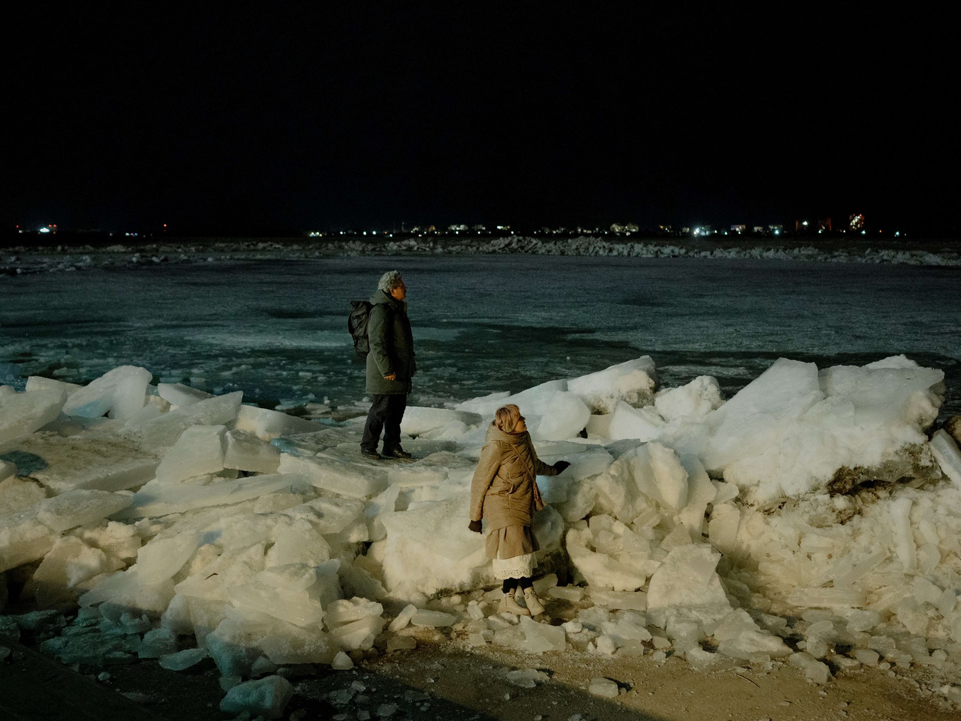 Ice crunches and cracks as the Tom River in Tomsk, Russia, begins to flow again with the spring thaw. Aliona and her parents come to the banks to watch it &ndash; as do many other people from the city: the ice drift each year is a major event, and makes the TV news.