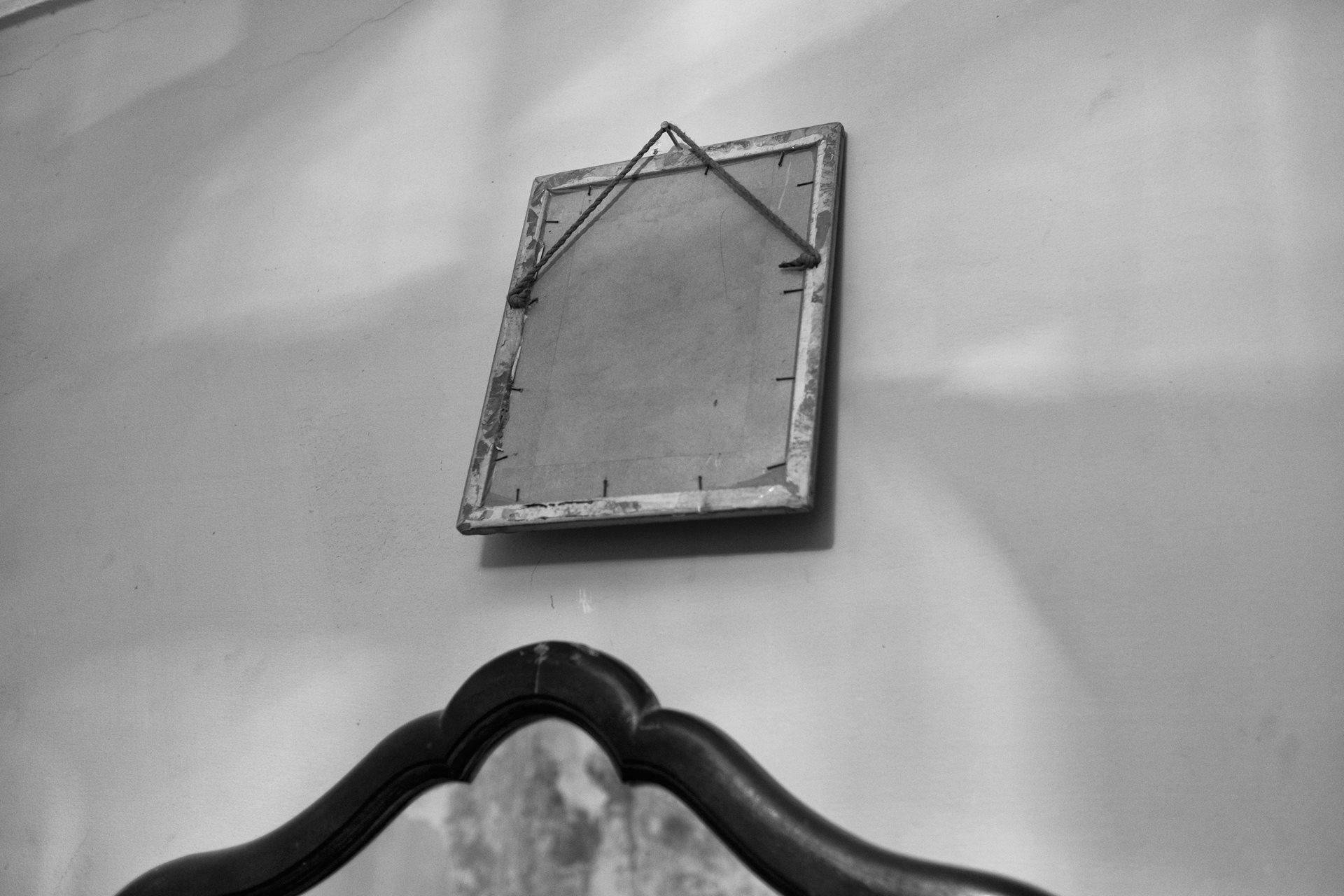 A photograph turned to face the wall. In some families, when someone dies, their image is flipped. Moon Valley, Alexandria, Egypt.