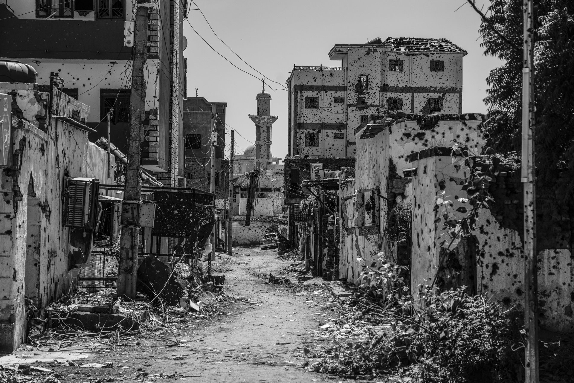 Damaged houses and the Sheikh GaribAllah Mosque in Wad Nubawi, Omdurman, Sudan. Religious and cultural sites have been attacked across the country.