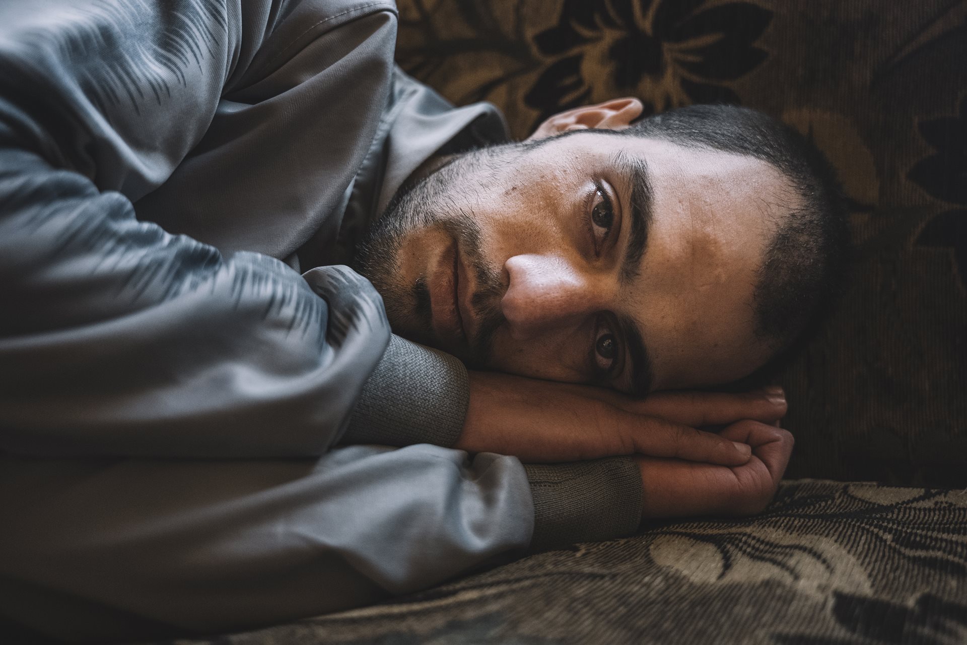 Mohamed Khaled Krayem, at home in Damascus, Syria, after seven years in prison for marijuana possession, finds his muscle memory instinctively reproduces the sleeping position he was forced to adopt in his crowded cell. Interrogators whipped his hands and feet, and beat him about the head to force him to confess that he was against the regime.