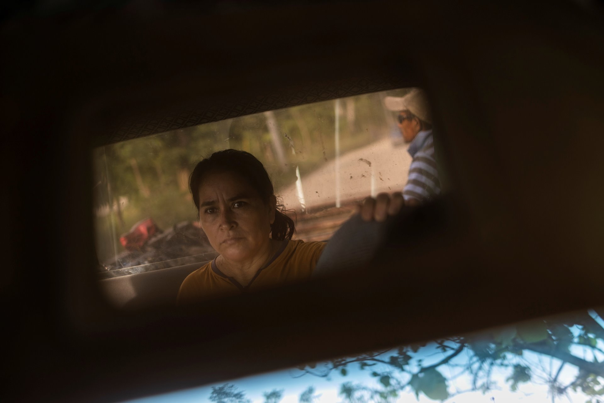 <p>Maria Hernandez rides in a pickup truck on the way to work at a banana plantation, in San Pedro Sula, Honduras, while awaiting a decision on her immigration case, in order to travel to the United States to reunite with her daughters.</p>
