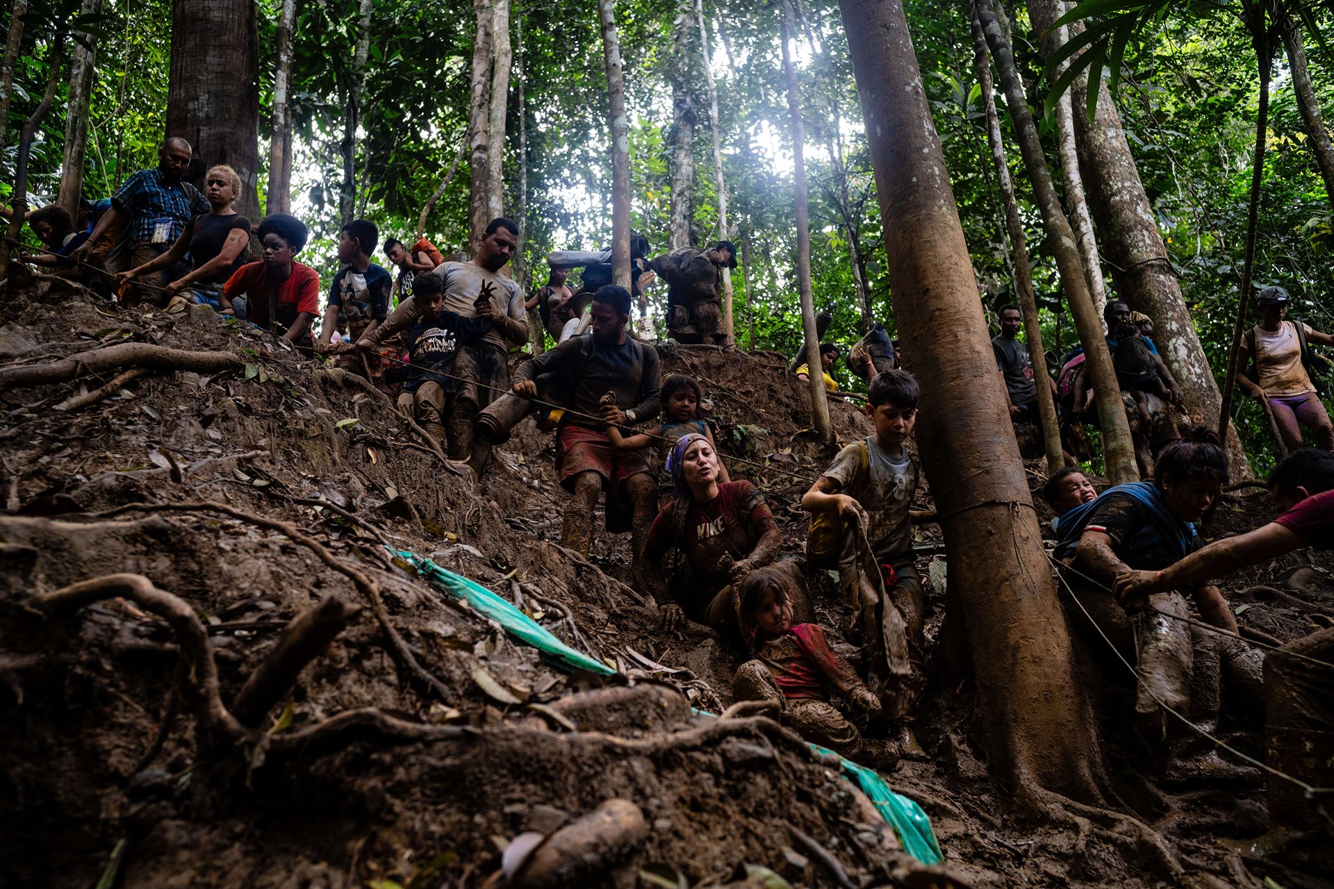 Over several days, Gabriel Ynfante (center, red shorts) held the hand of 6-year-old Francheska Lopez as they trekked through the jungle. Although she was not his daughter, he supported her through the journey, singing &quot;Bartolito,&quot; a traditional children&#39;s song, to keep her entertained.