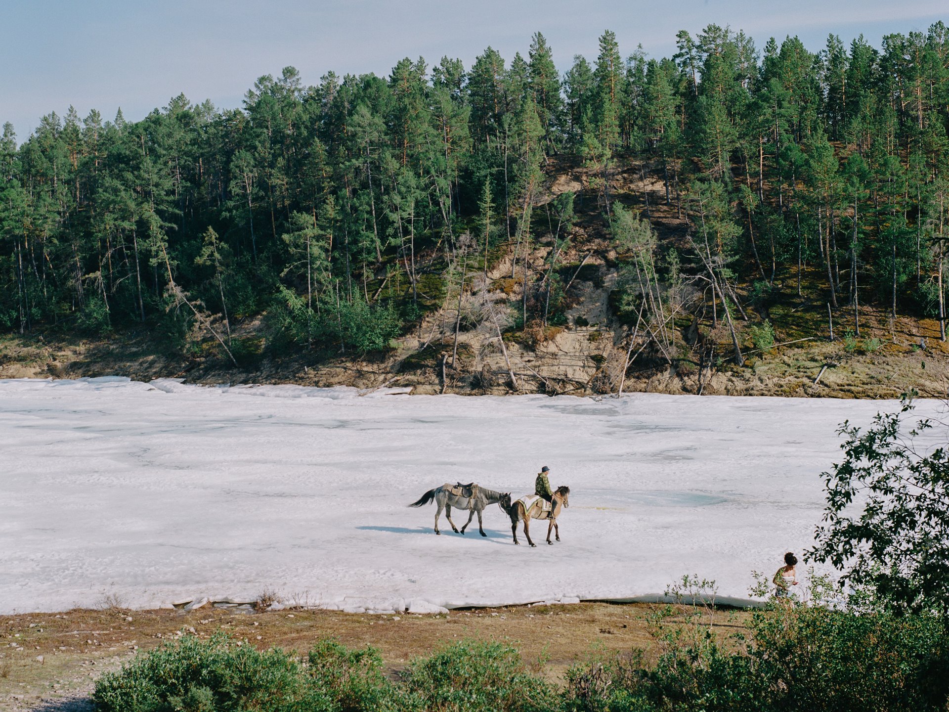 People walk along the Buluus glacier, which lies in a deep valley some 100 km from Yakutsk, and is a popular retreat in summer months when temperatures in the capital reach the high 30s Celsius, in Sakha, Siberia, Russia. Permafrost beneath the glacier keeps at least part of it frozen through the summer months, but The Siberian Times reported local scientists as saying that glacial melt in the region has sped up in the past ten years.&nbsp;