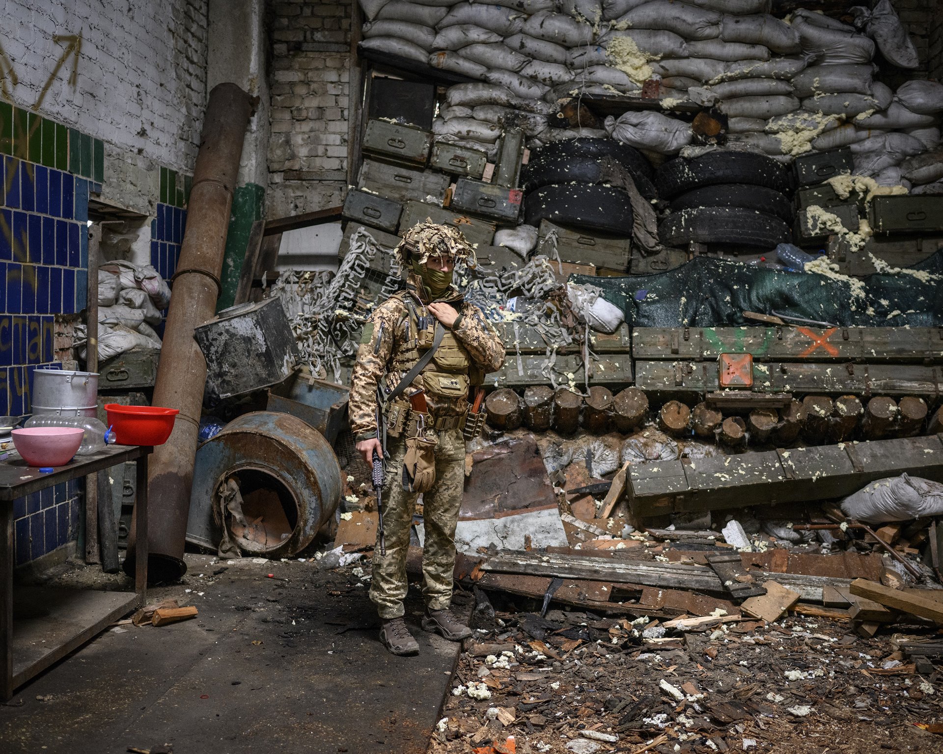 A Ukrainian soldier stands beside a barrier made with sandbags and old ammunition boxes in a building in the Promzona industrial zone, in the town of Avdiivka, in Donbas, Ukraine. The Promzona industrial zone was seen as strategically significant, as it provided control over the M04 highway, which was the most direct transport route between the separatist HQ in Donetsk and Horlivka, another large frontline city.
